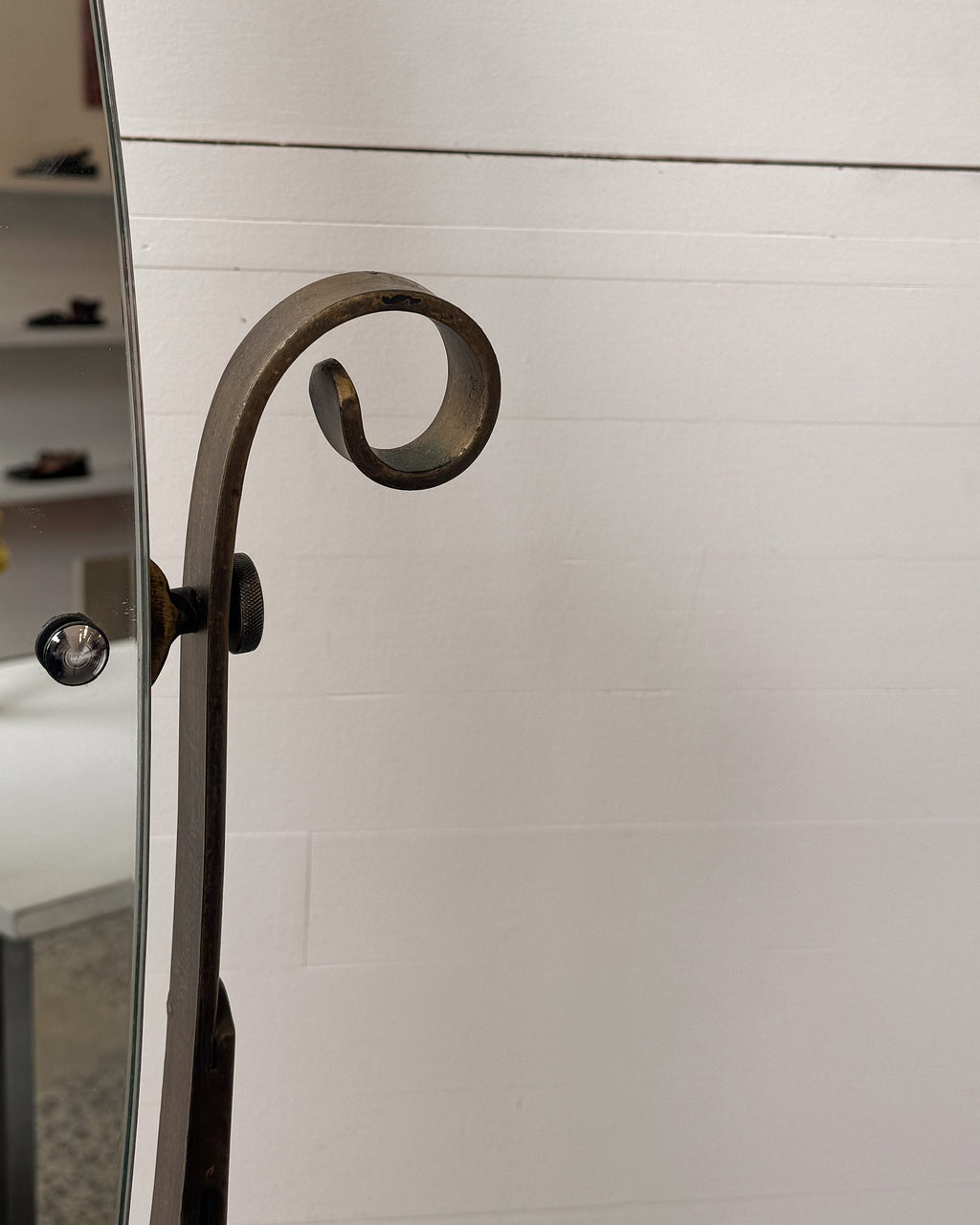 Full length swivel mirror on metal body with bronzed finish and spiral details