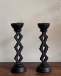 Pair of black wooden candle holders with diamond pattern