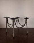Metal candle holder with twist detail feet