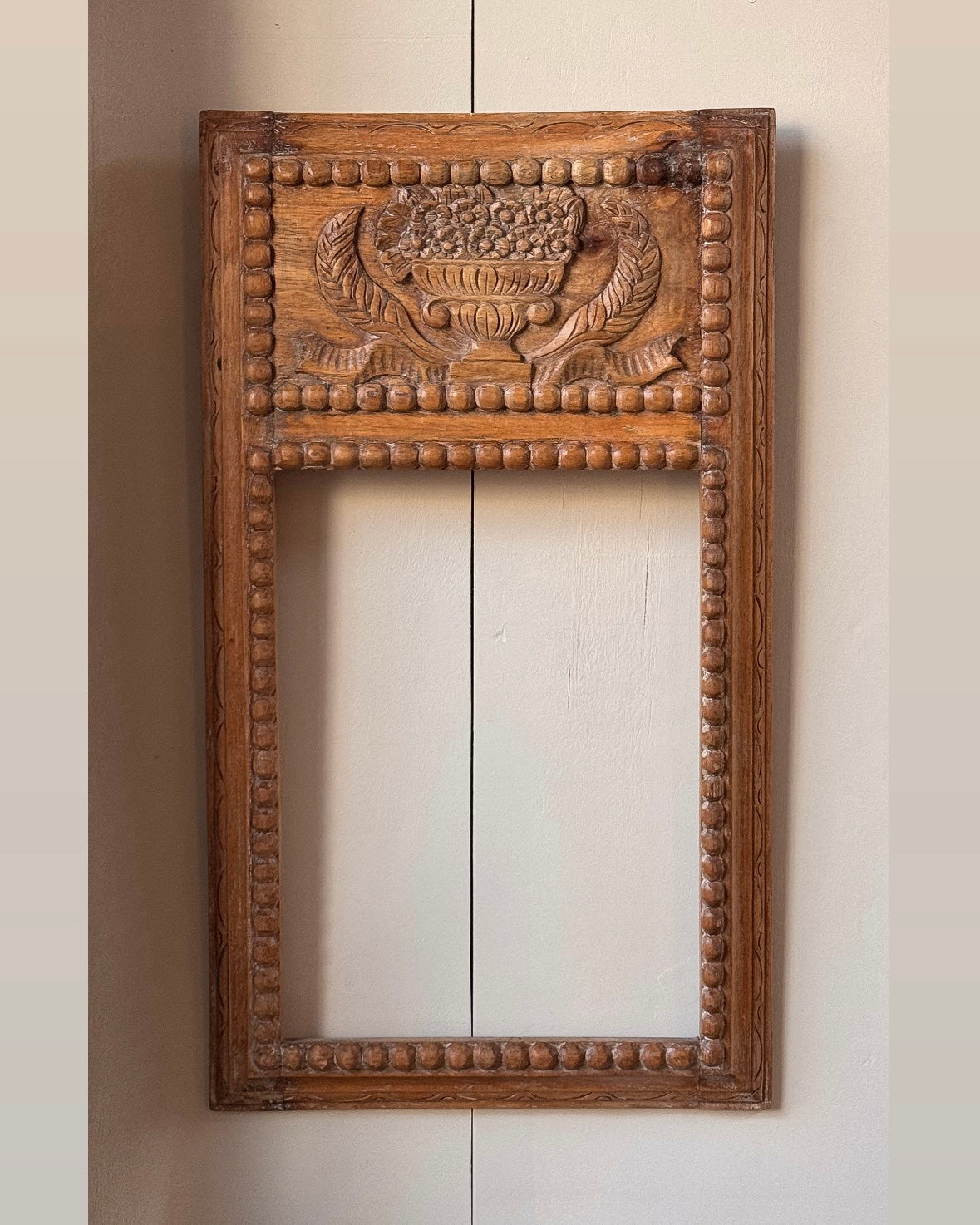 Hand carved wooden picture/mirror frame with clasical urn of flowers