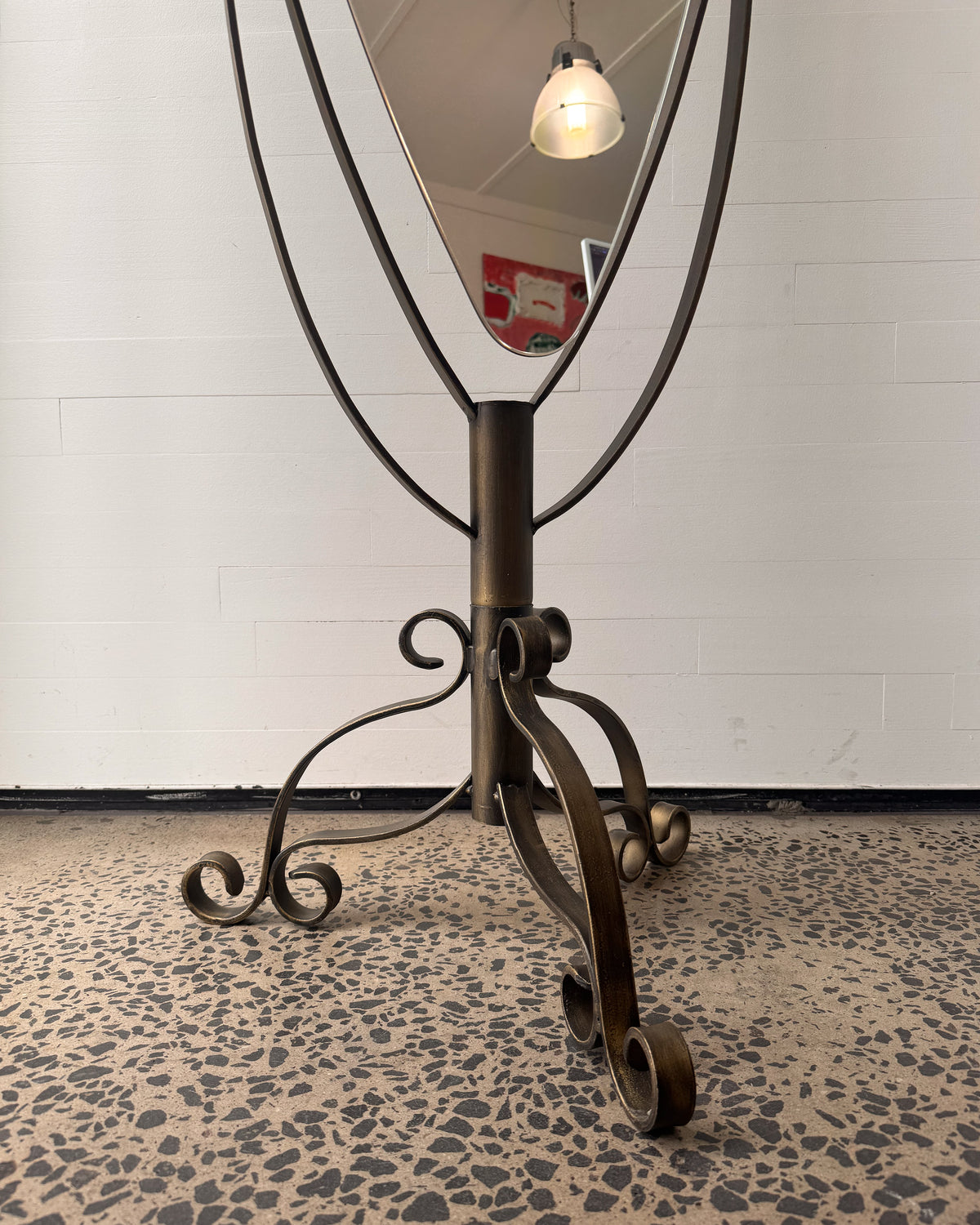 Full length swivel mirror on metal body with bronzed finish and spiral details