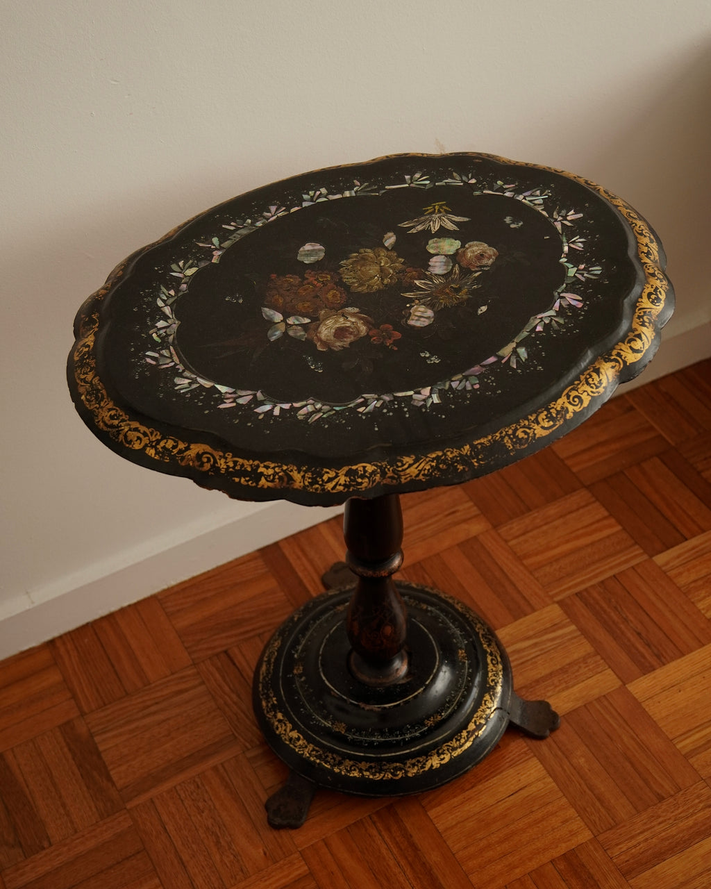 Paper mache and mother of pearl inlaid table likely made between mid to late 19th century