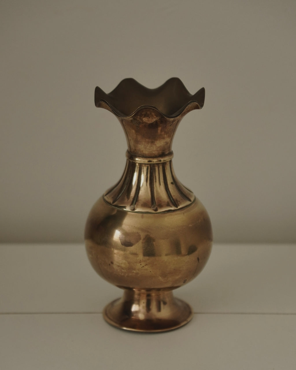 Brass vase with tapered neck and scalloped opening