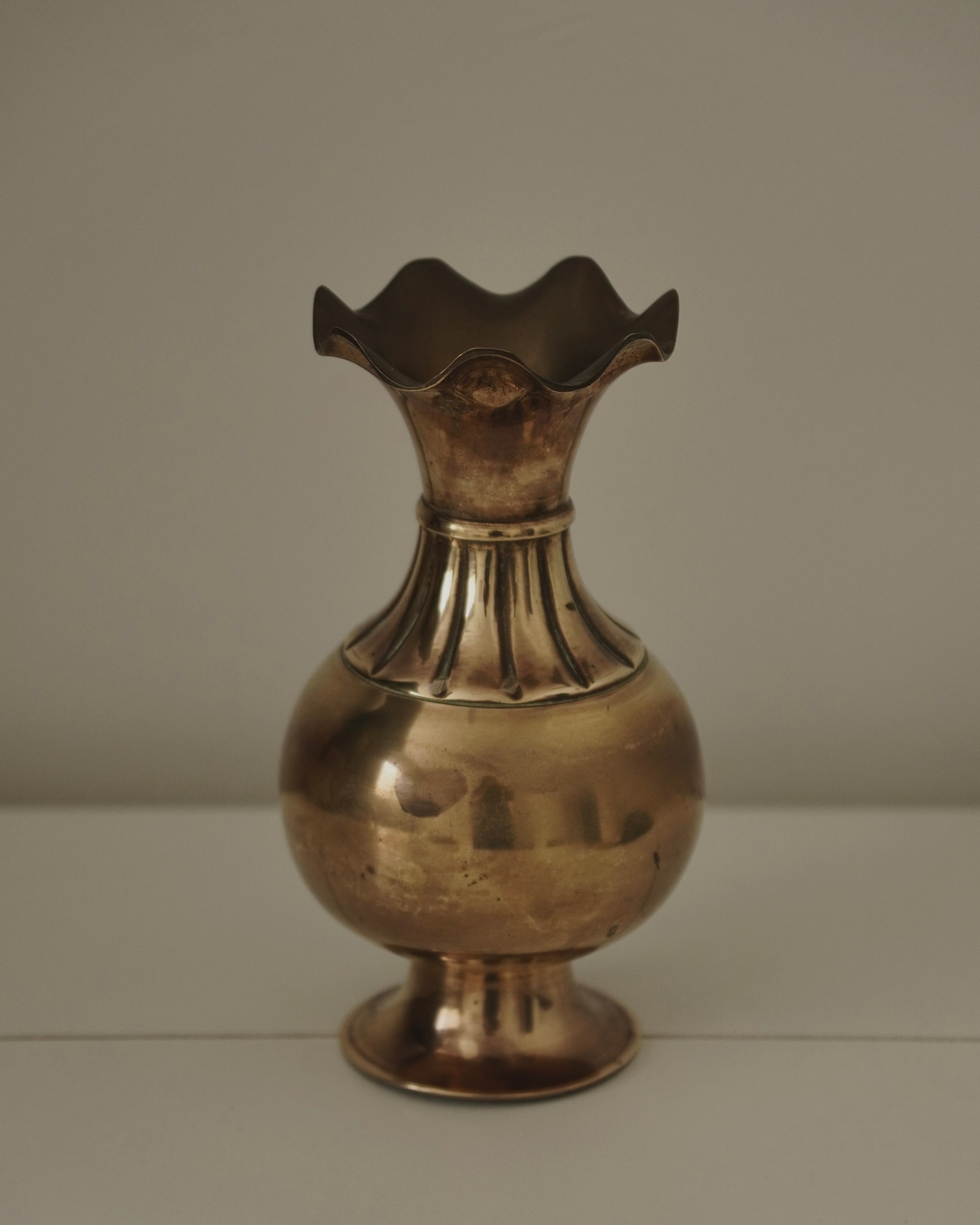 Brass vase with tapered neck and scalloped opening
