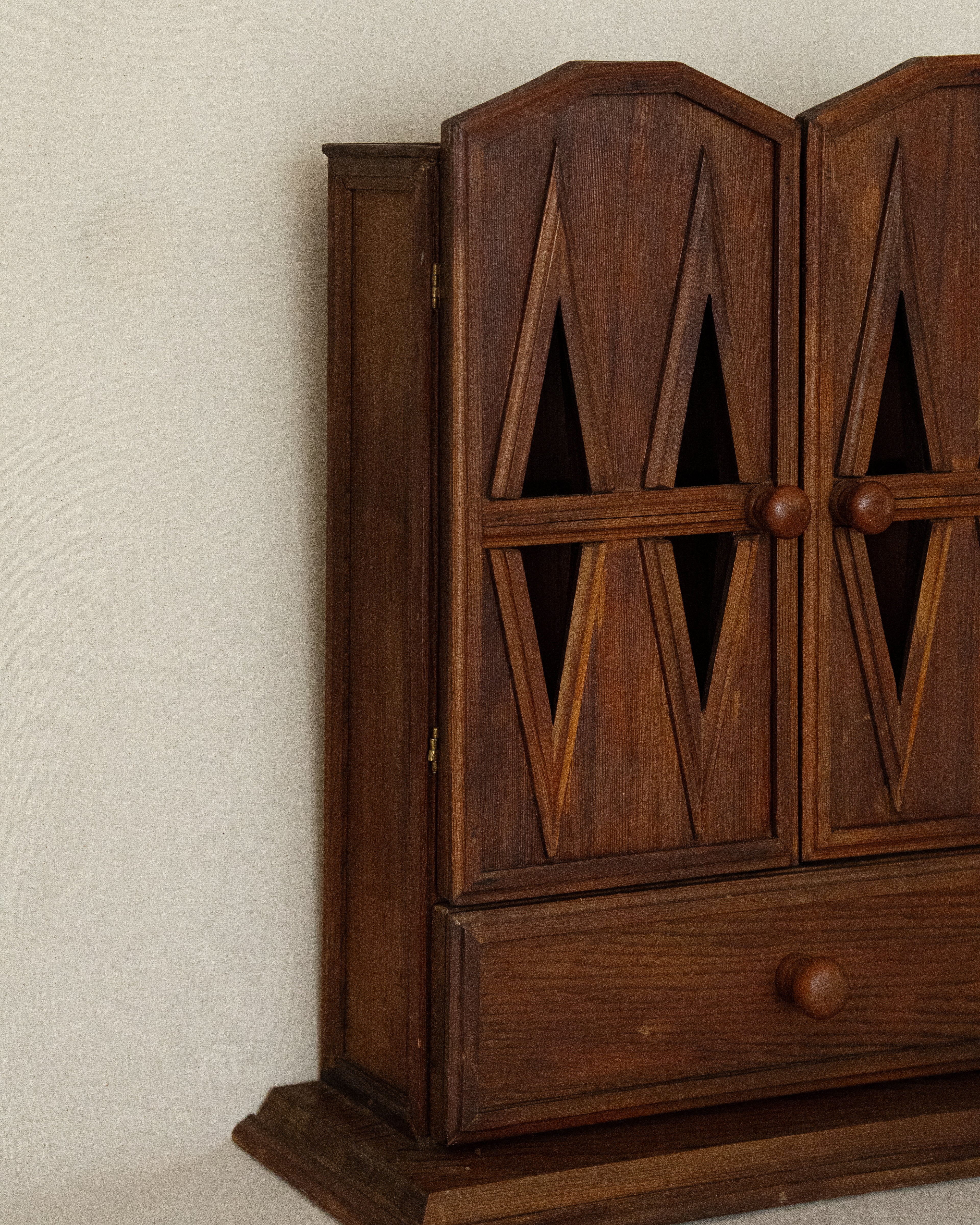 Wooden gothic style cabinet with shelving, two doors and a drawer
