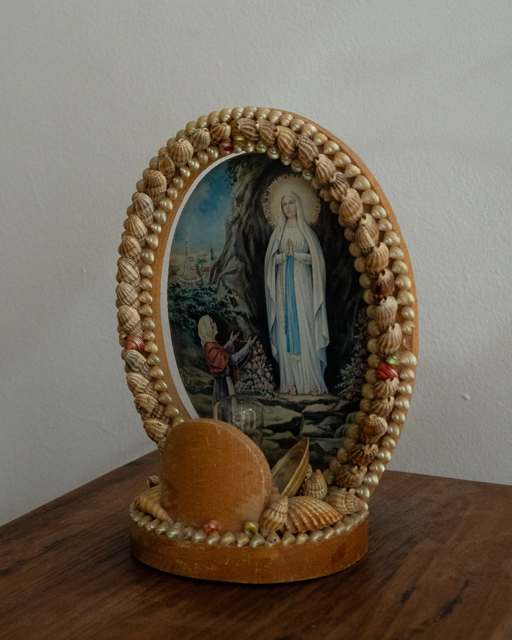 Shell table lamp encasing religious scene