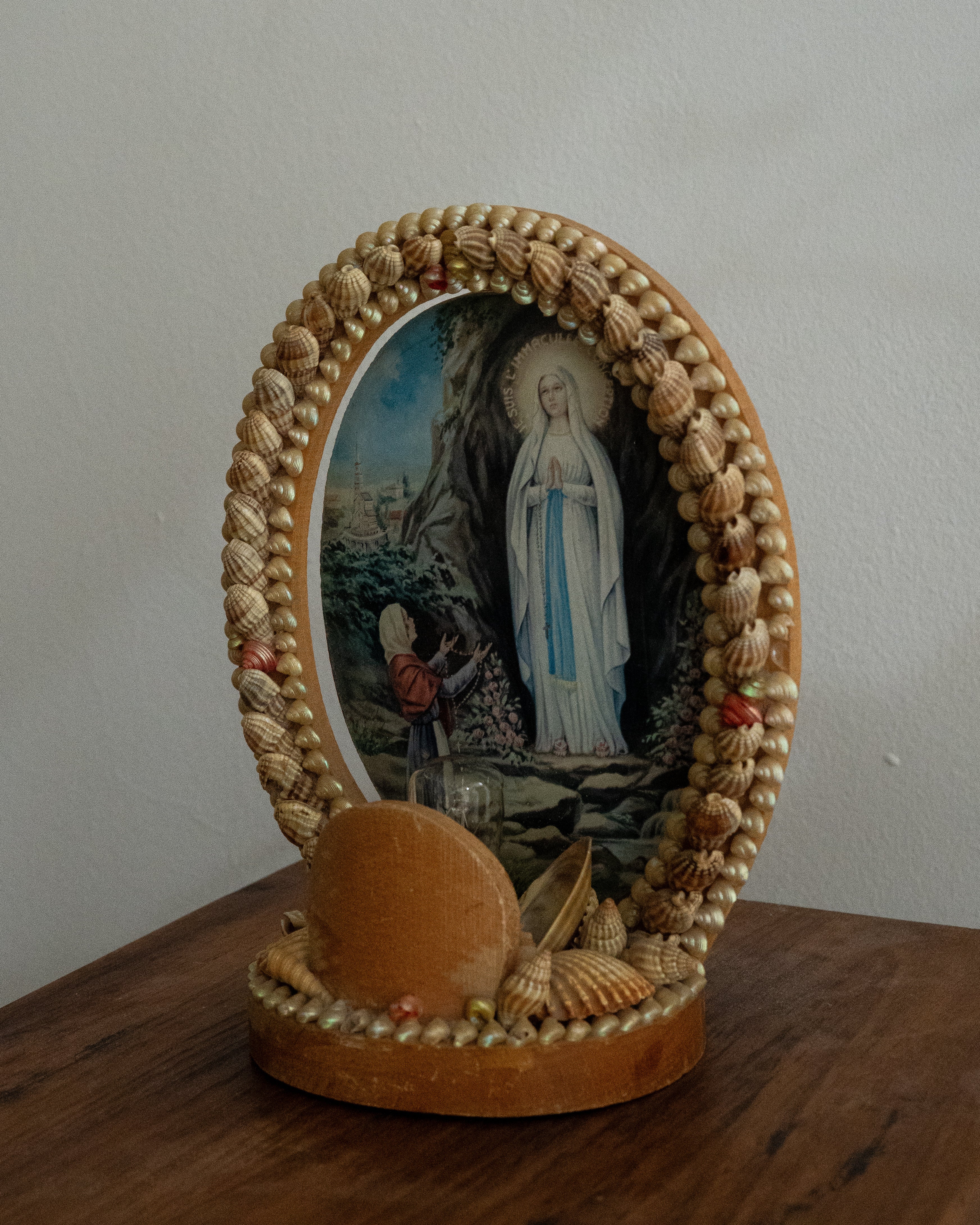 Shell table lamp encasing religious scene