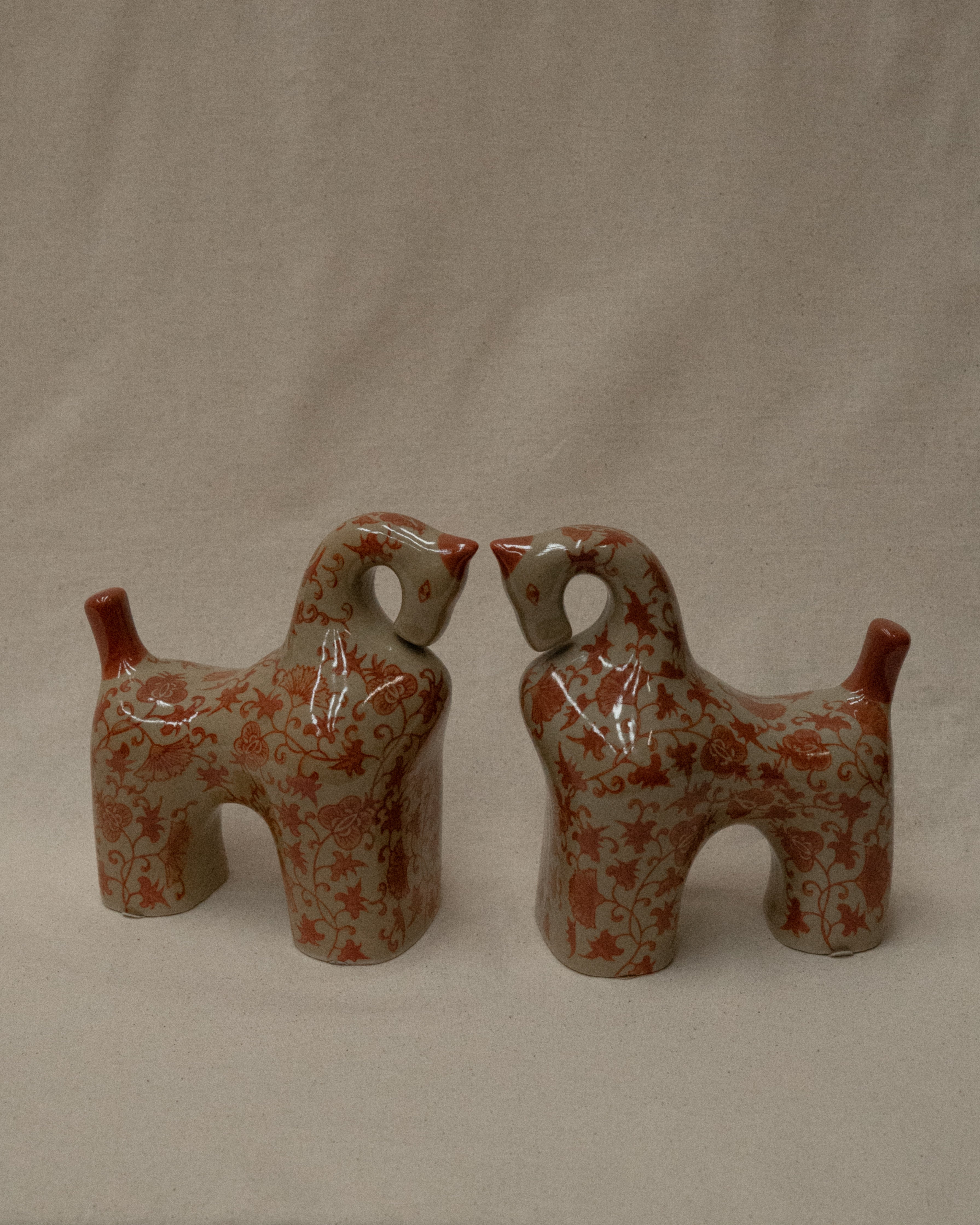 Pair of ceramic horses in pink and brown