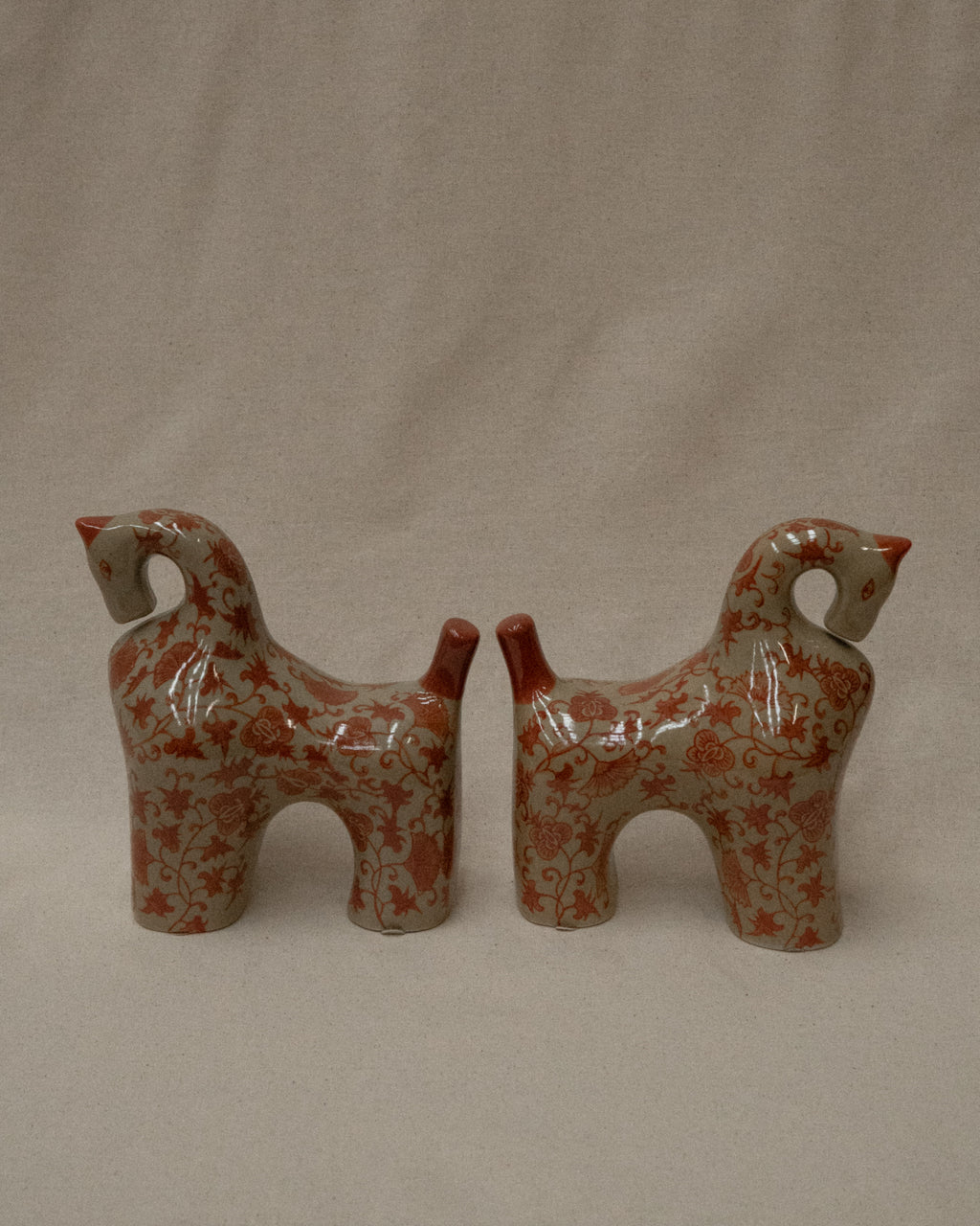 Pair of ceramic horses in pink and brown