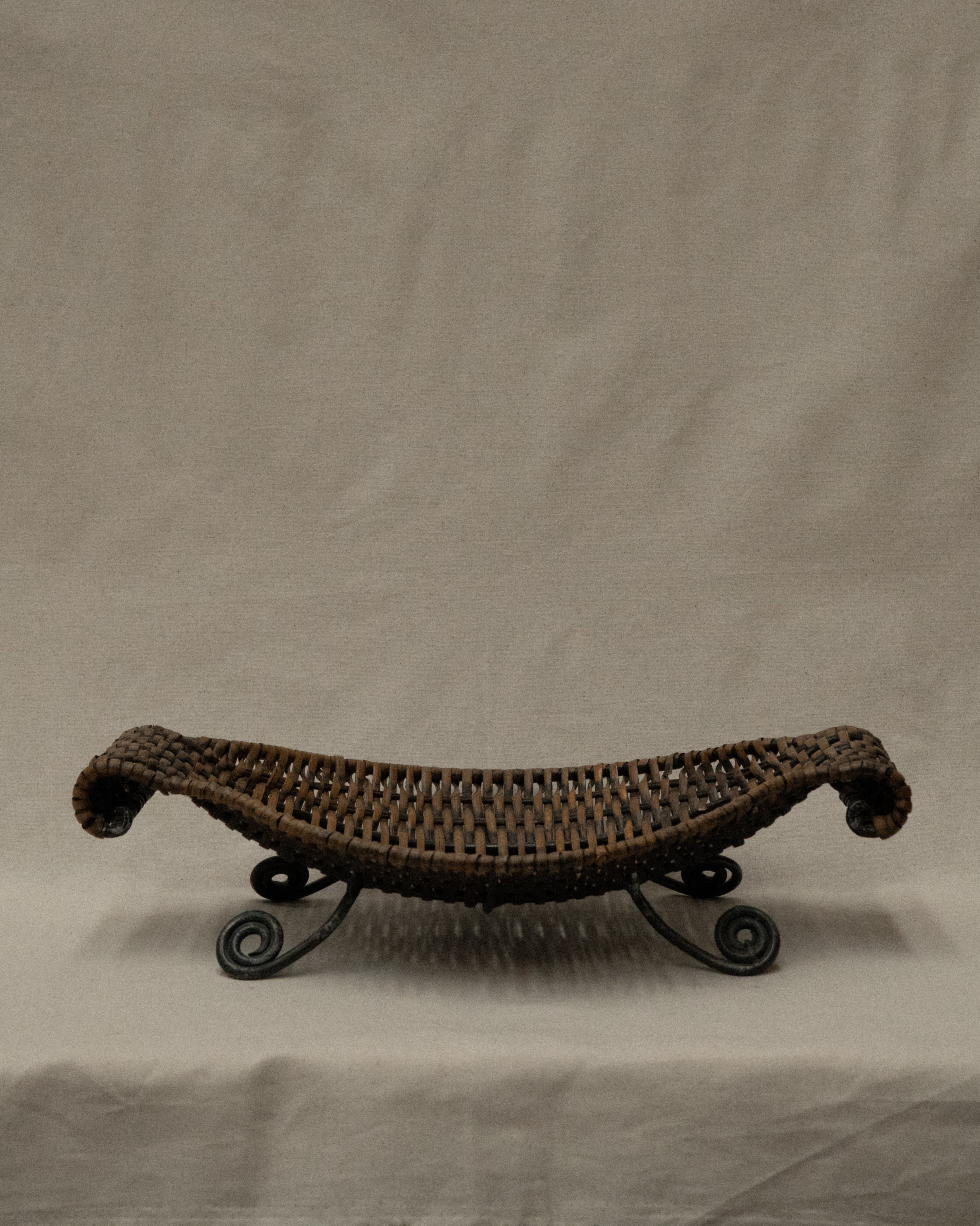Woven bowl with metal frame and spiral feet