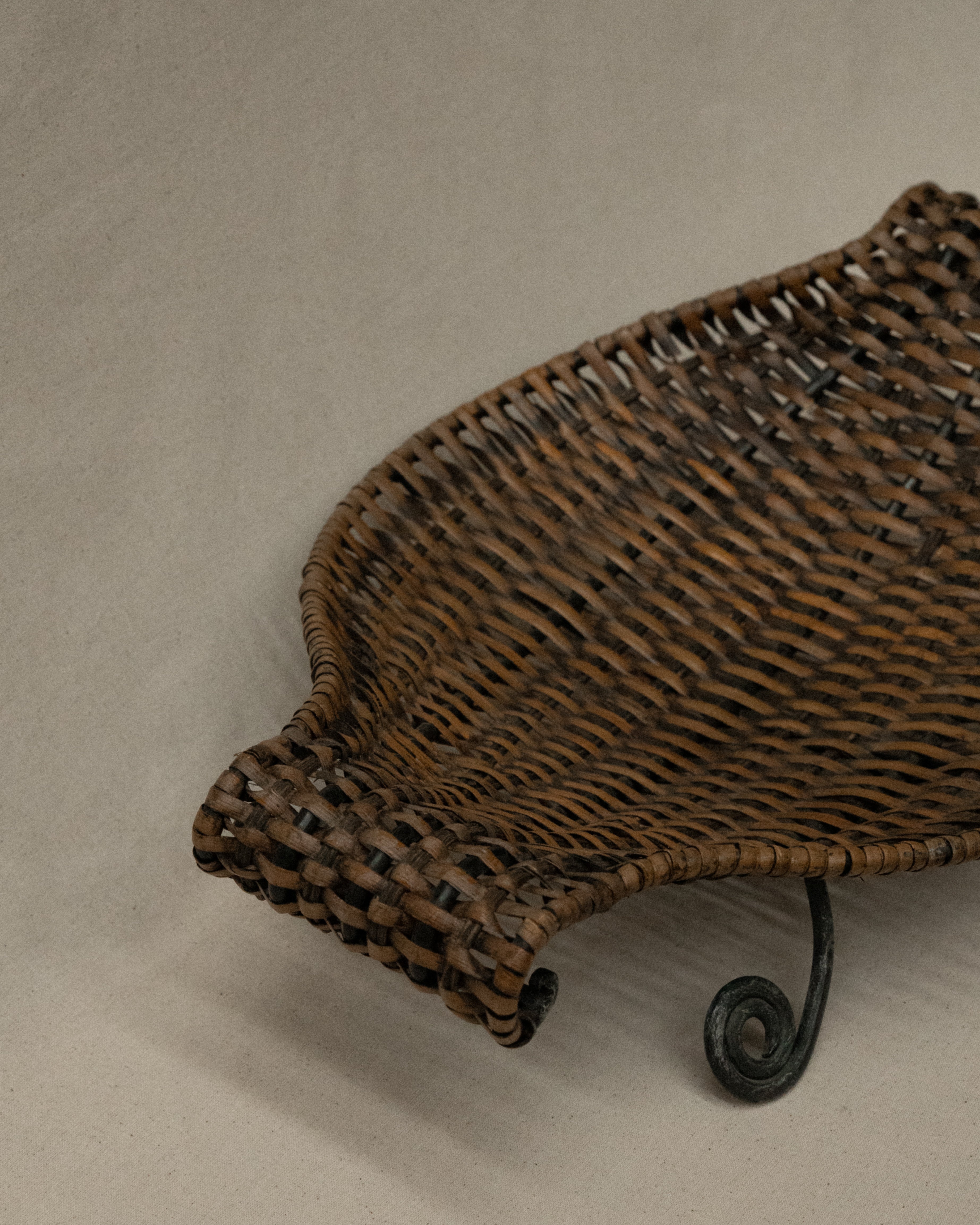 Woven bowl with metal frame and spiral feet