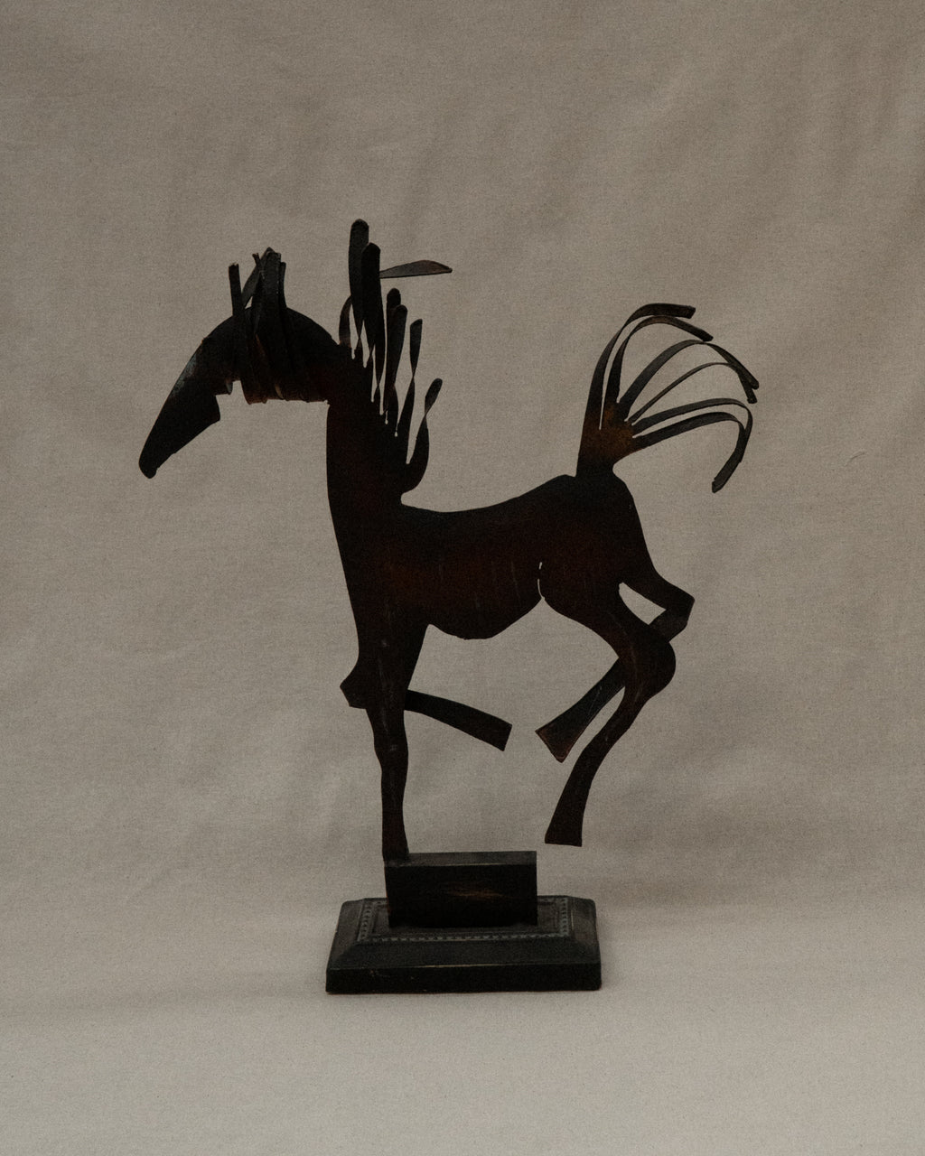 Brutalist metal horse sculpture with intentional patina