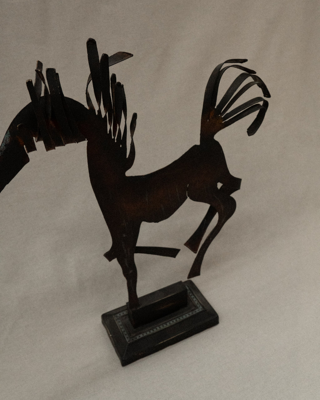 Brutalist metal horse sculpture with intentional patina