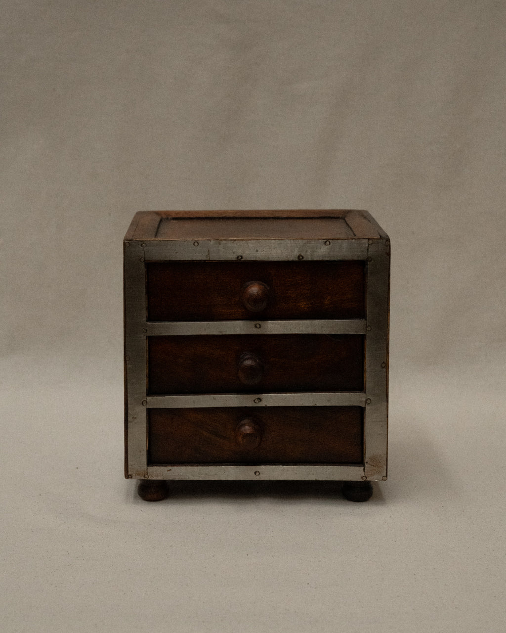 Wooden box with metal front and three drawers
