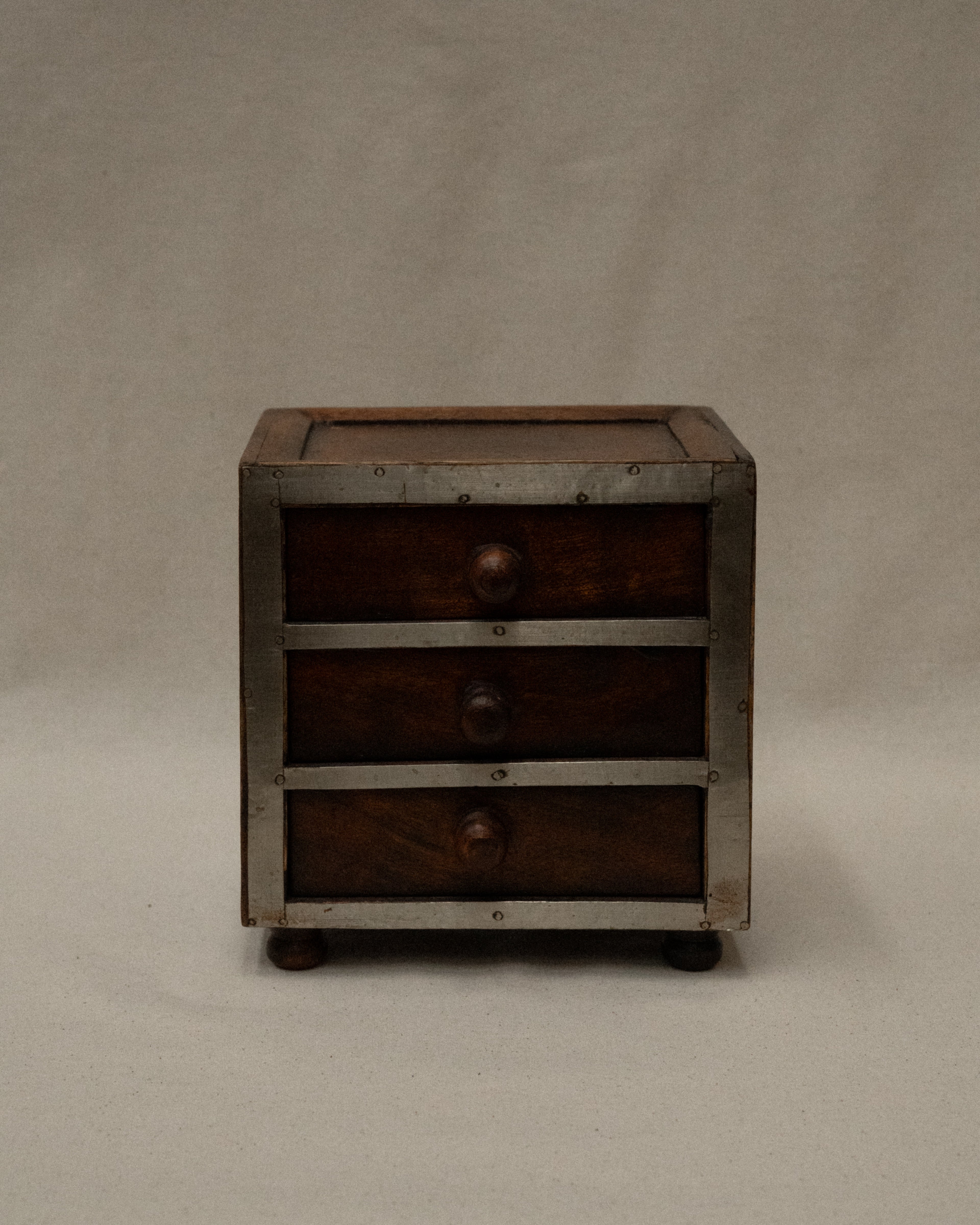 Wooden box with metal front and three drawers