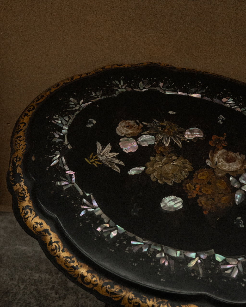 Paper mache and mother of pearl inlaid table likely made between mid to late 19th century