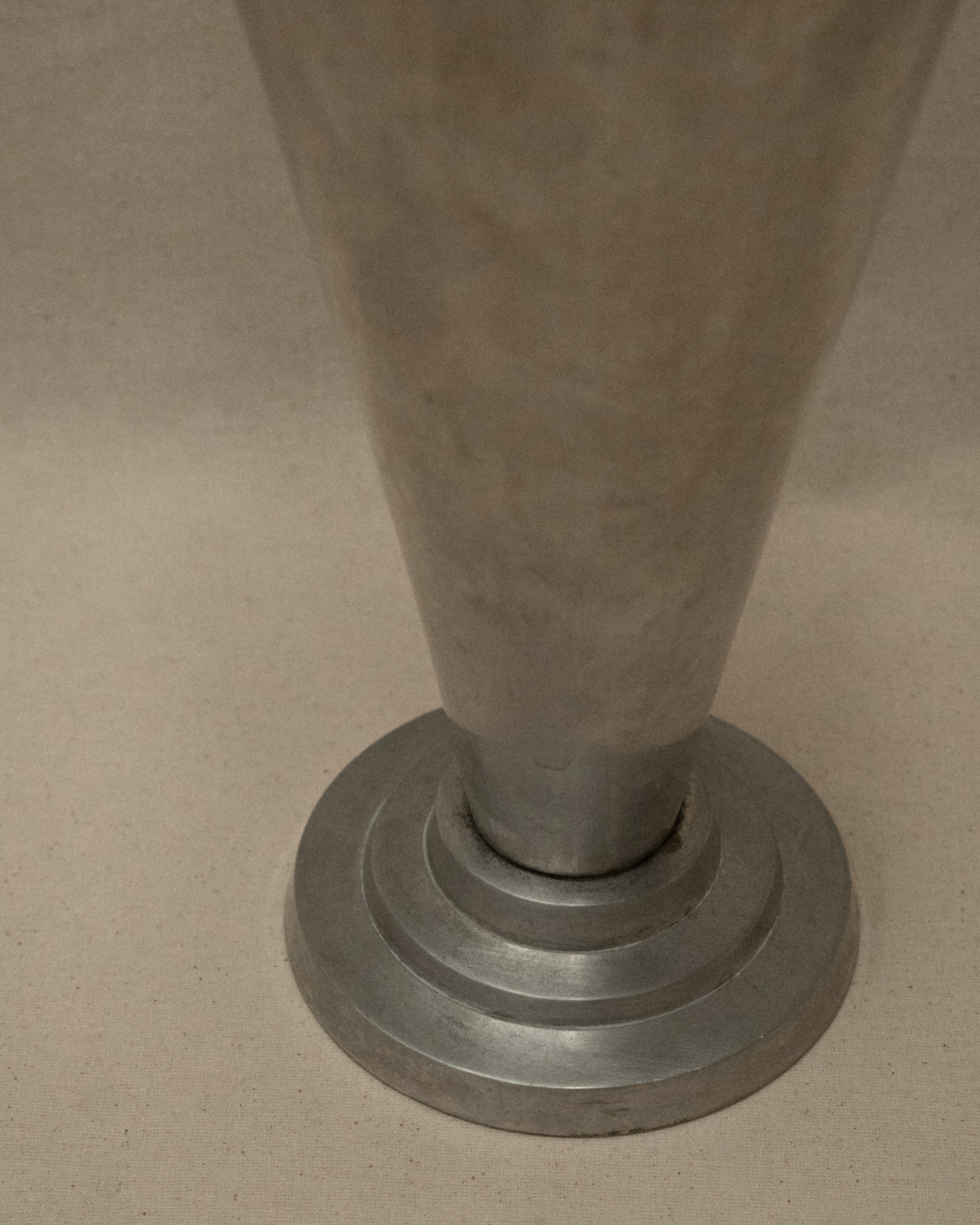 Art deco style conical footed aluminum vase