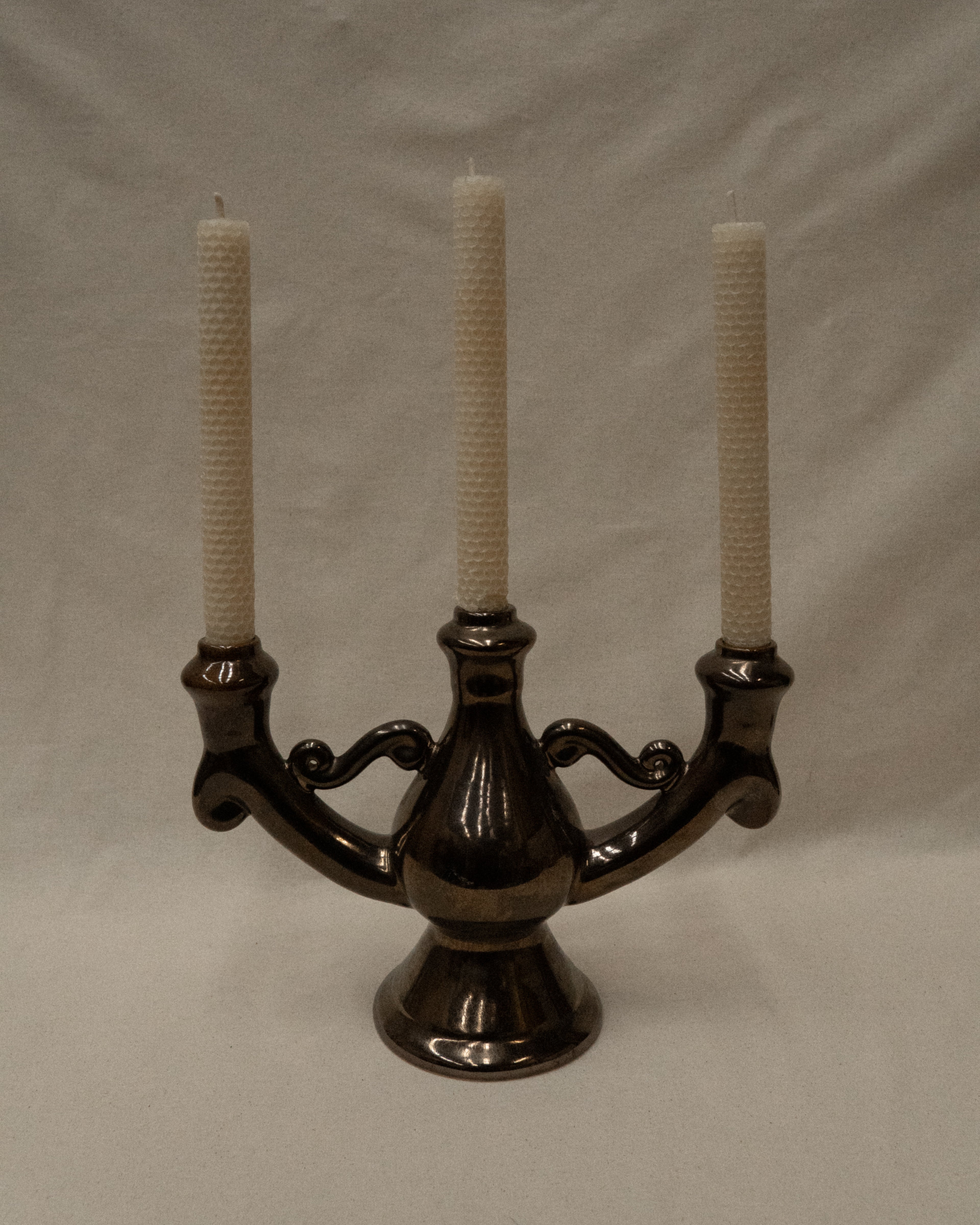 Ceramic candelabra with a reflective brown glaze