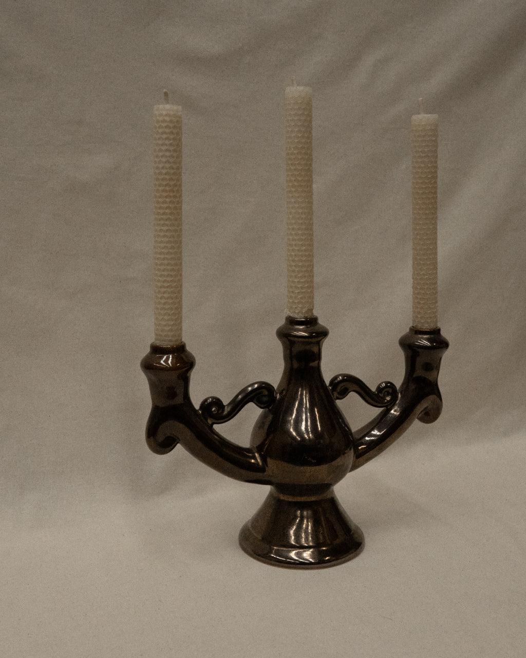 Ceramic candelabra with a reflective brown glaze