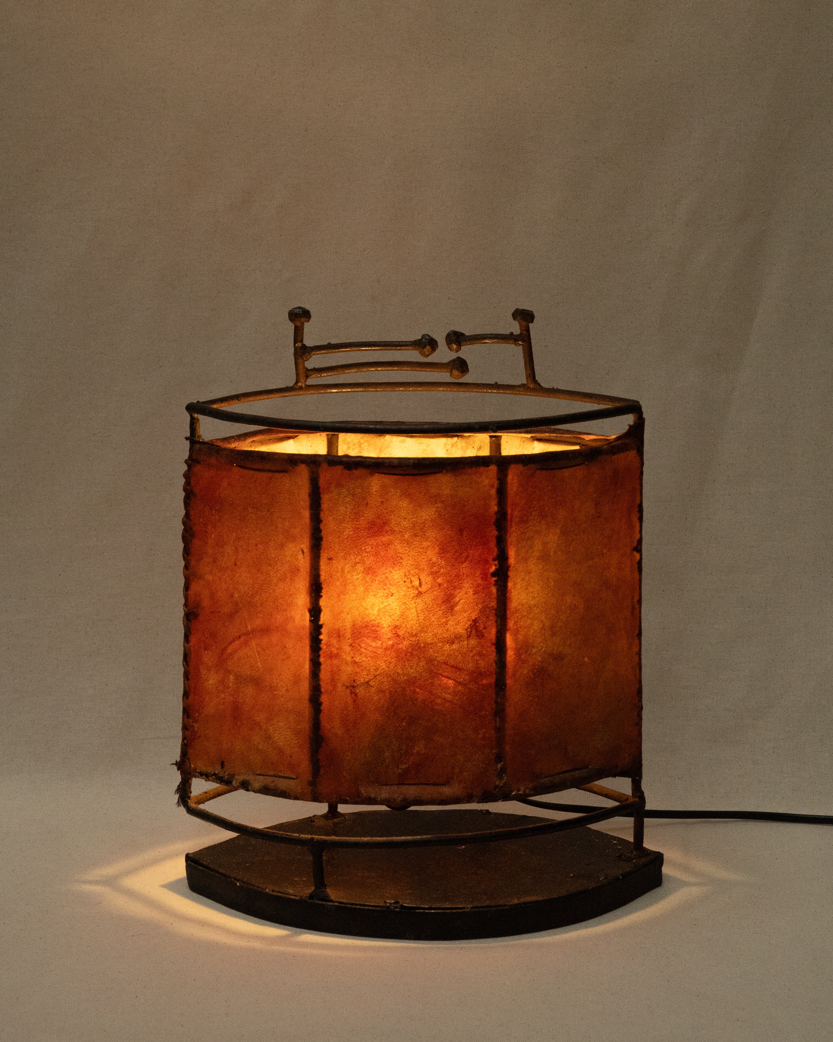 Wrought iron and stained goat hide lamp