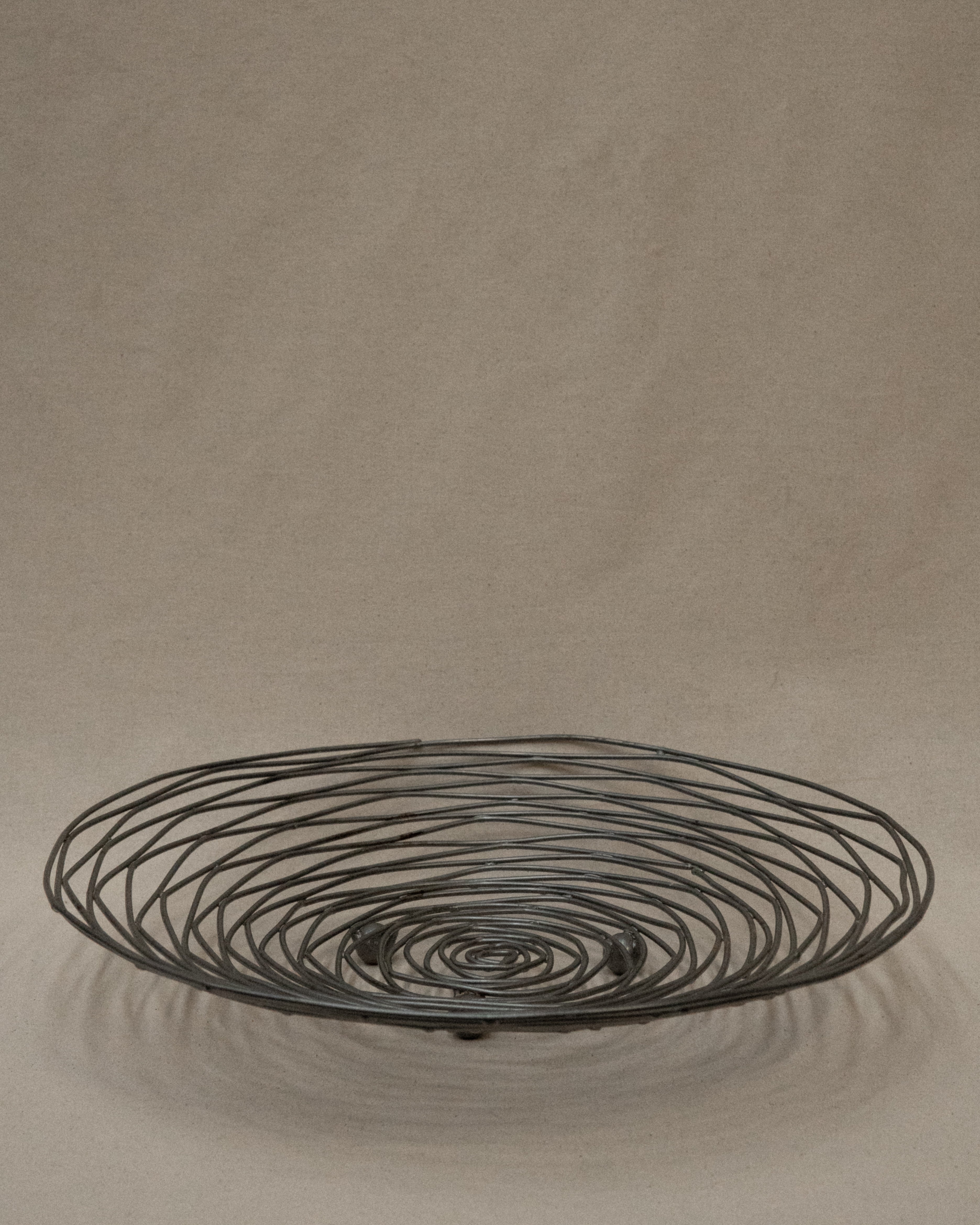 Shallow large wire like metal bowl with round soldering details