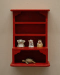 Orange red painted wooden trinket display shelf