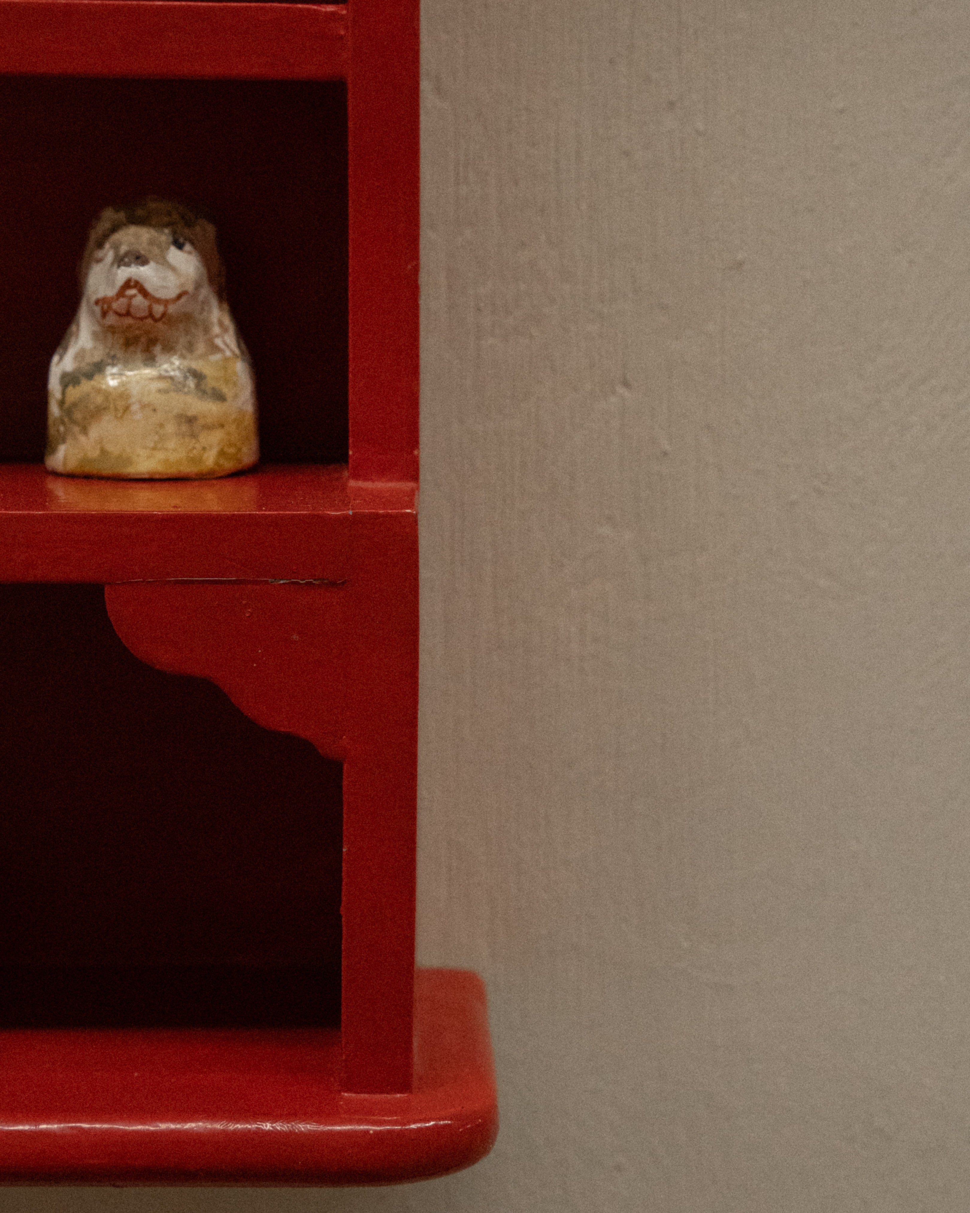 Orange red painted wooden trinket display shelf