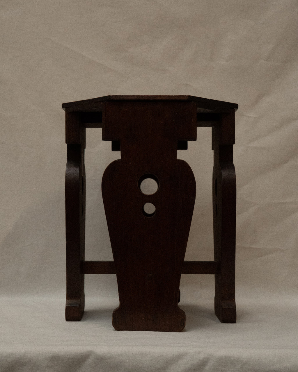 Wooden stool with vase shaped supports