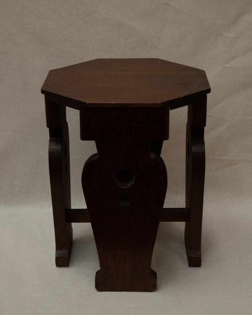 Wooden stool with vase shaped supports