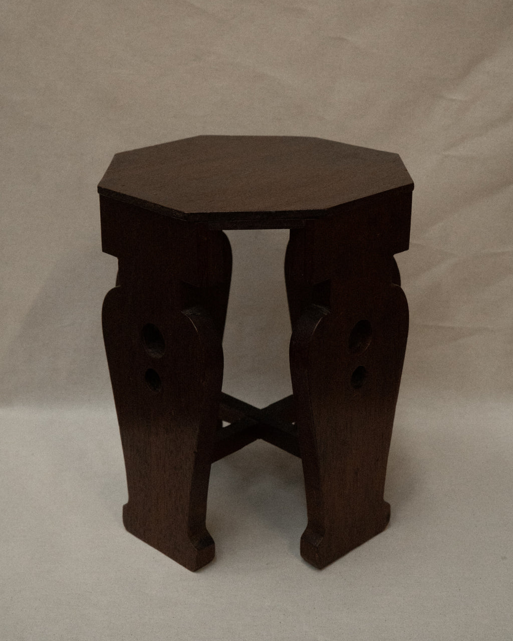 Wooden stool with vase shaped supports