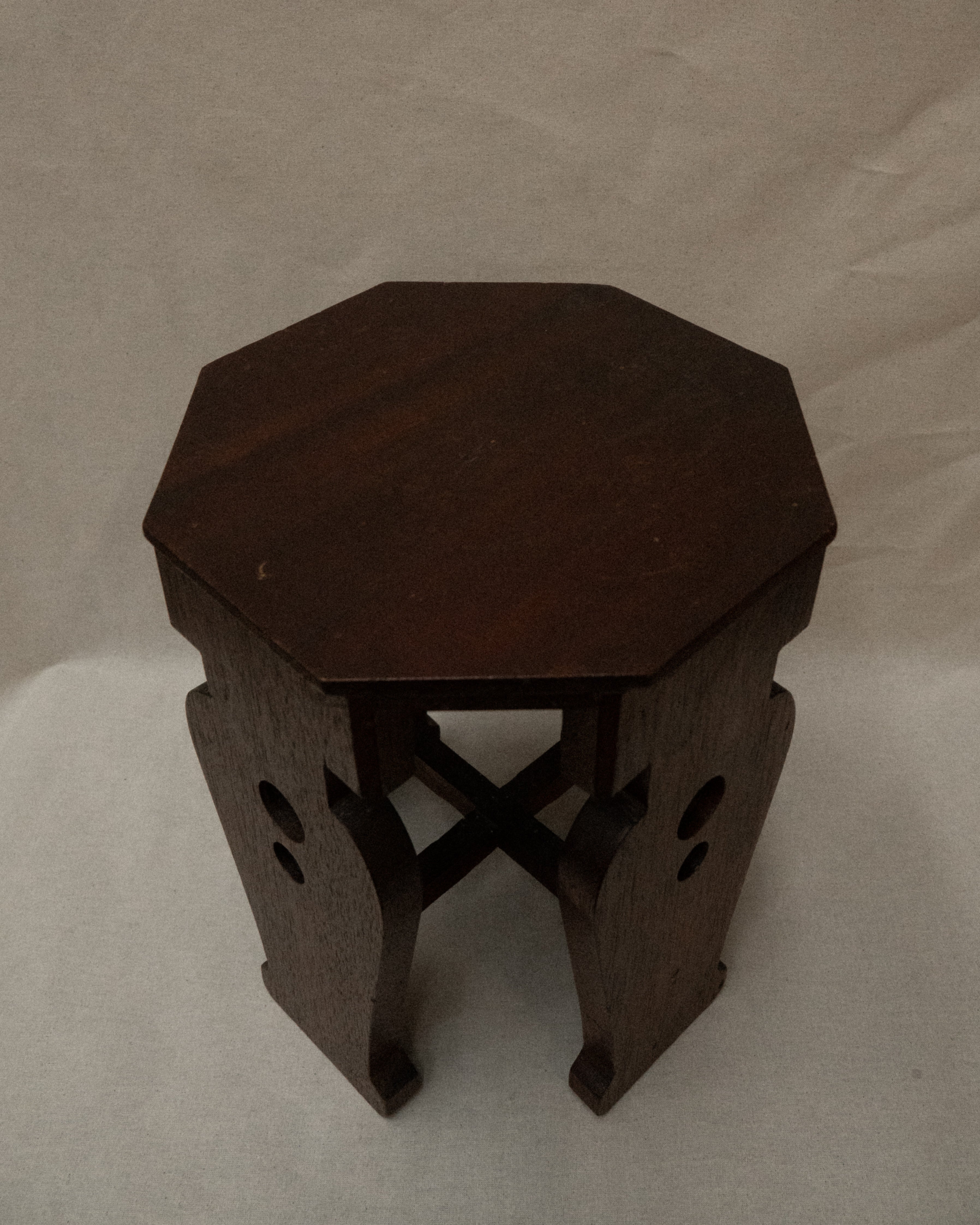 Wooden stool with vase shaped supports