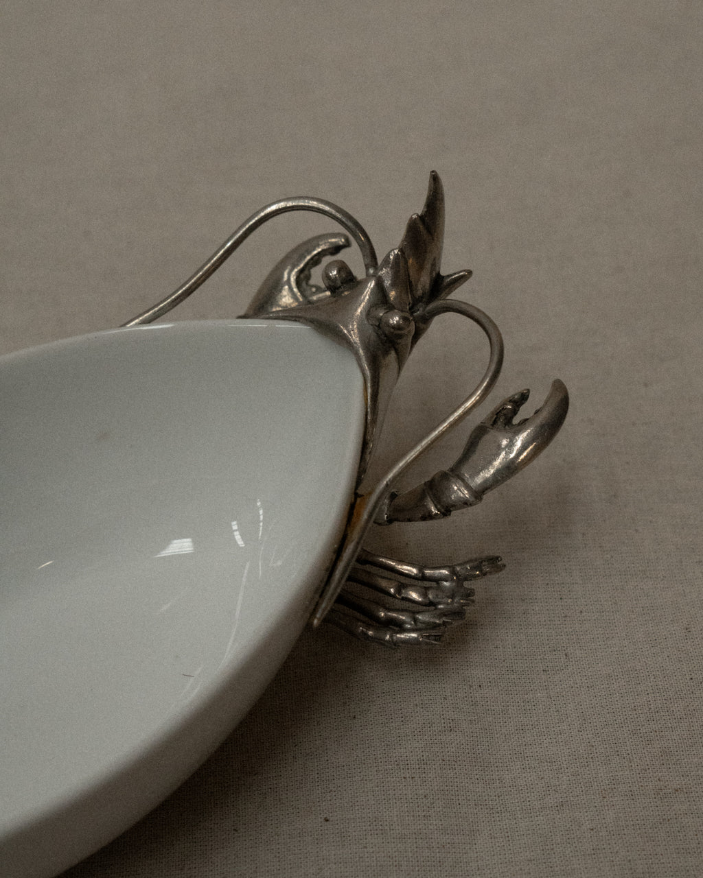 White ceramic dish with silver coloured lobster