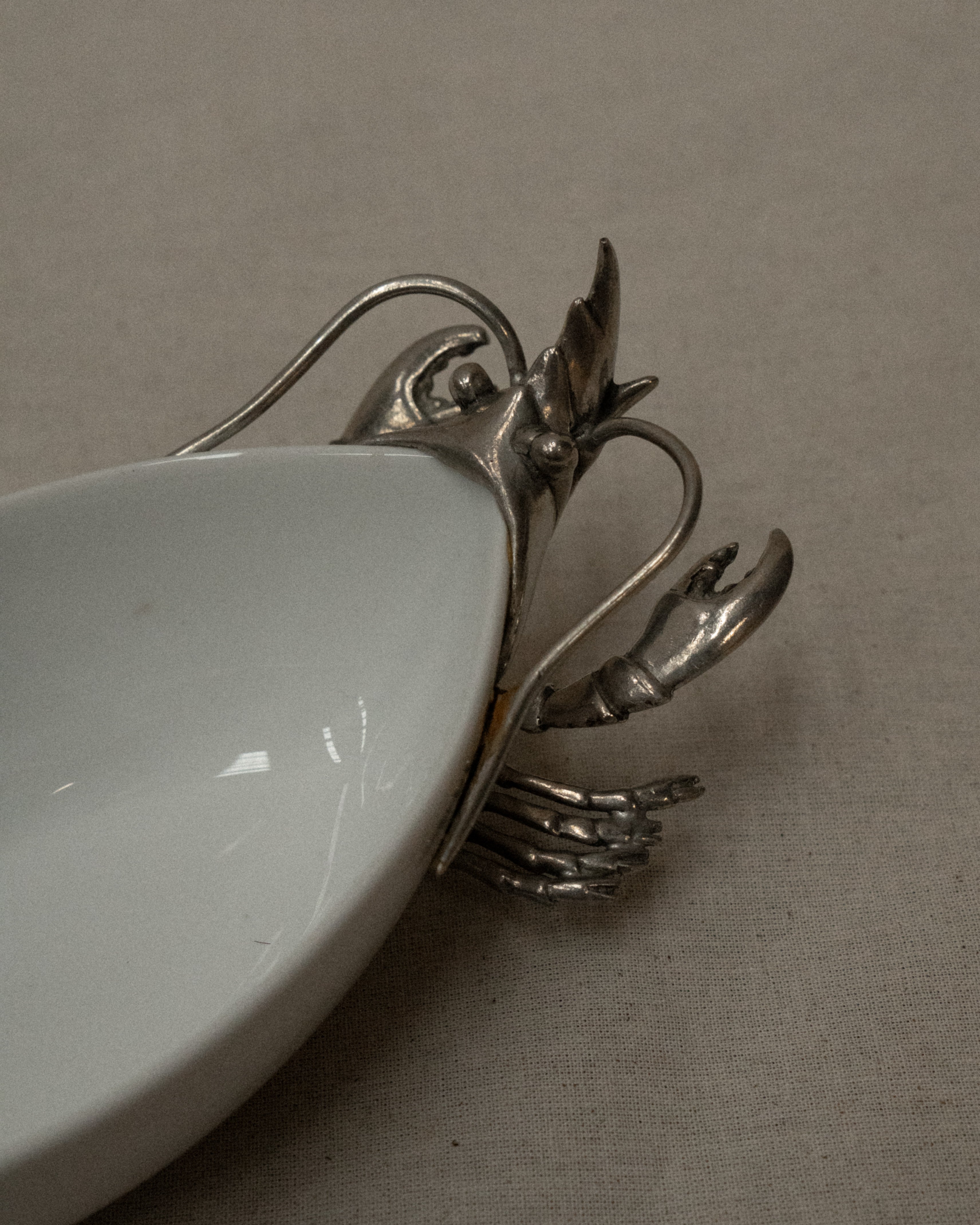 White ceramic dish with silver coloured lobster