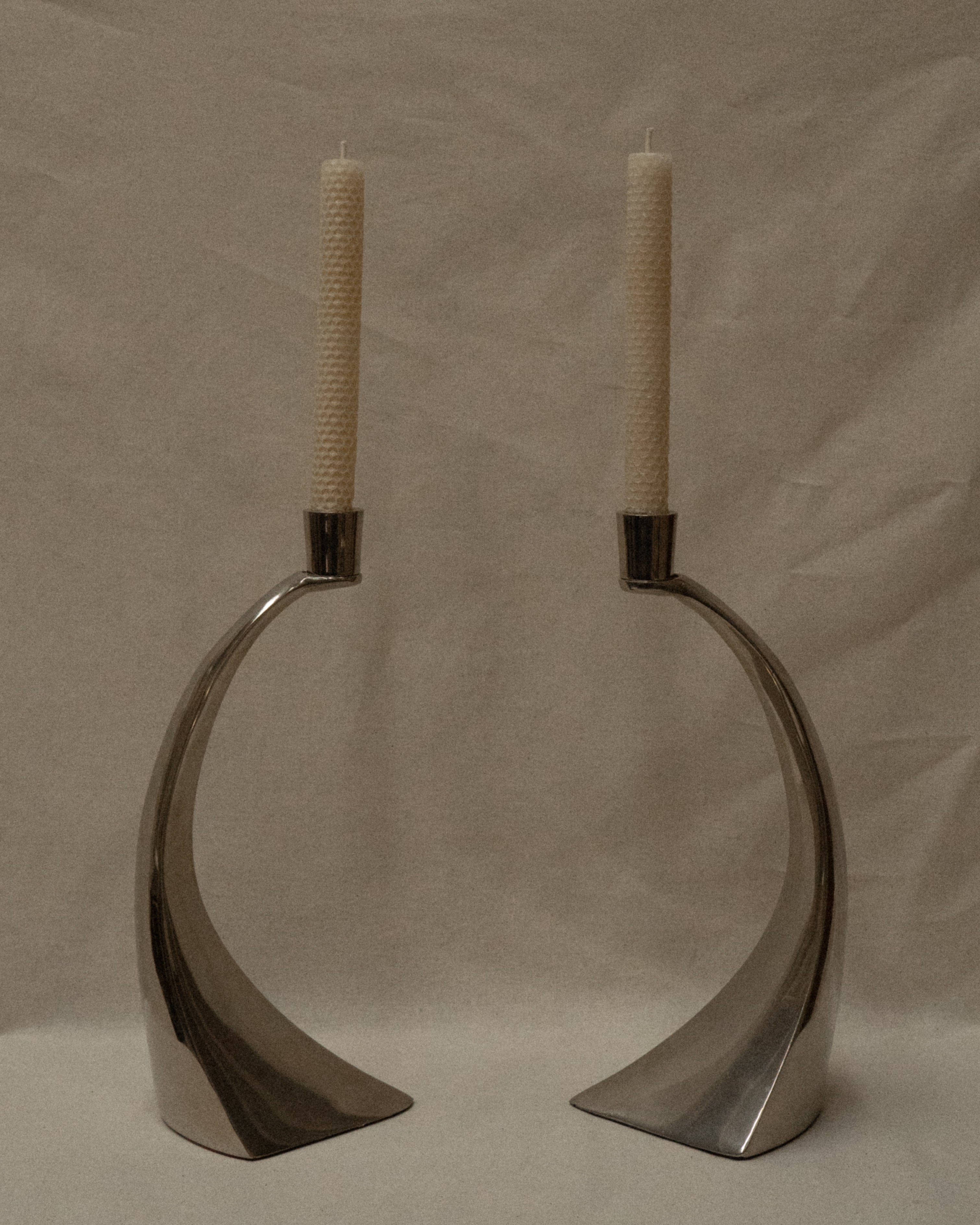 Pair of curved chrome candle holders