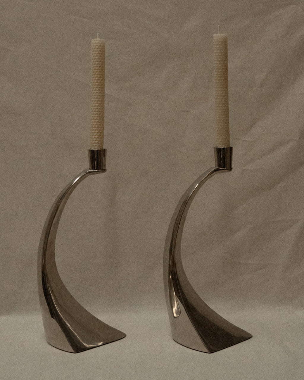 Pair of curved chrome candle holders