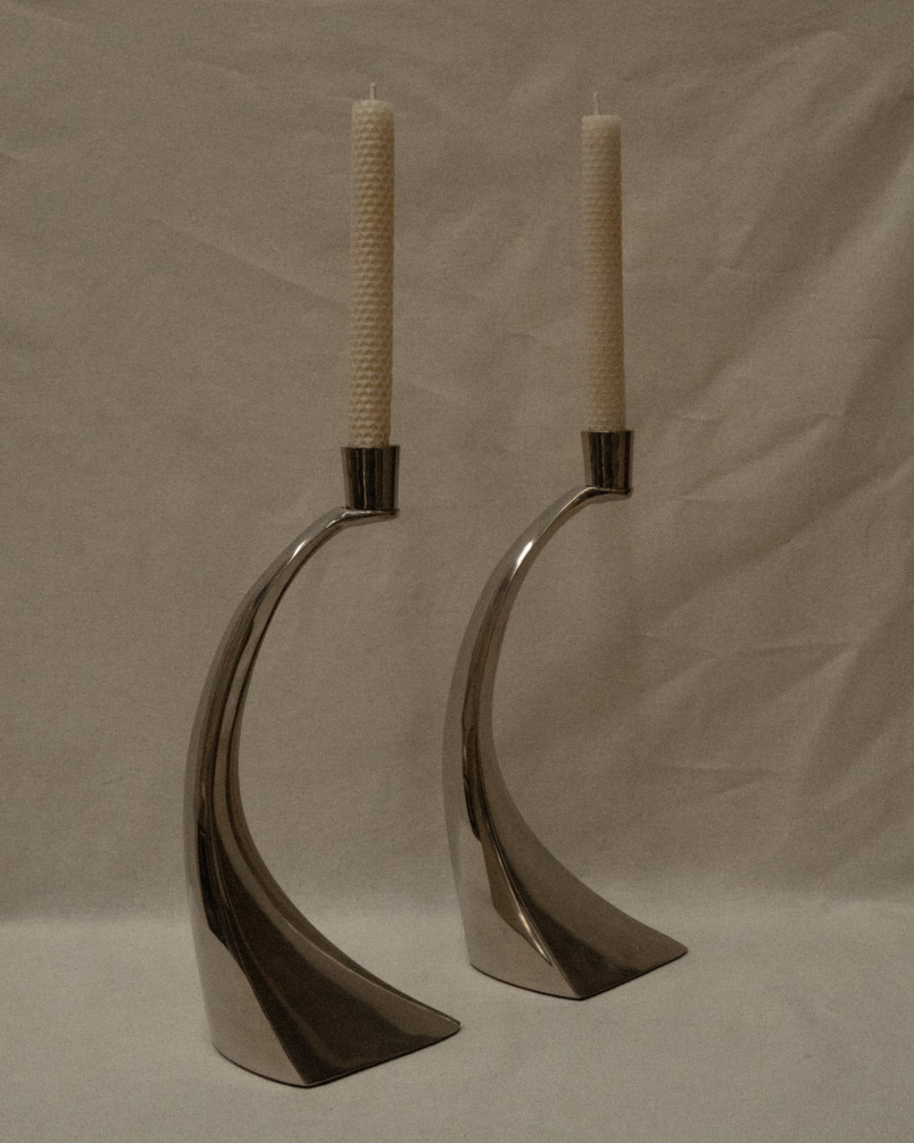 Pair of curved chrome candle holders