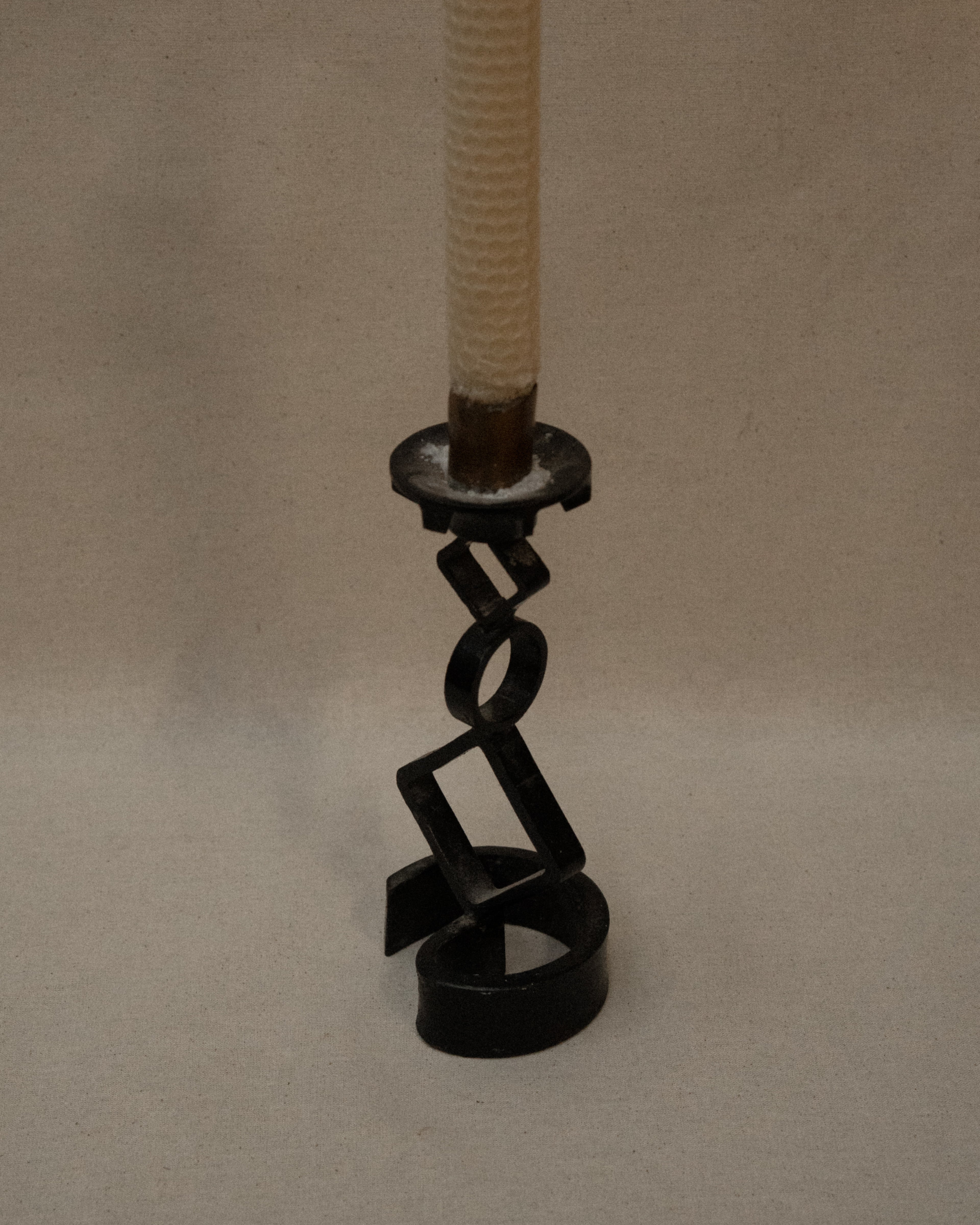 Black steel candle holder with diamond and circle shapes