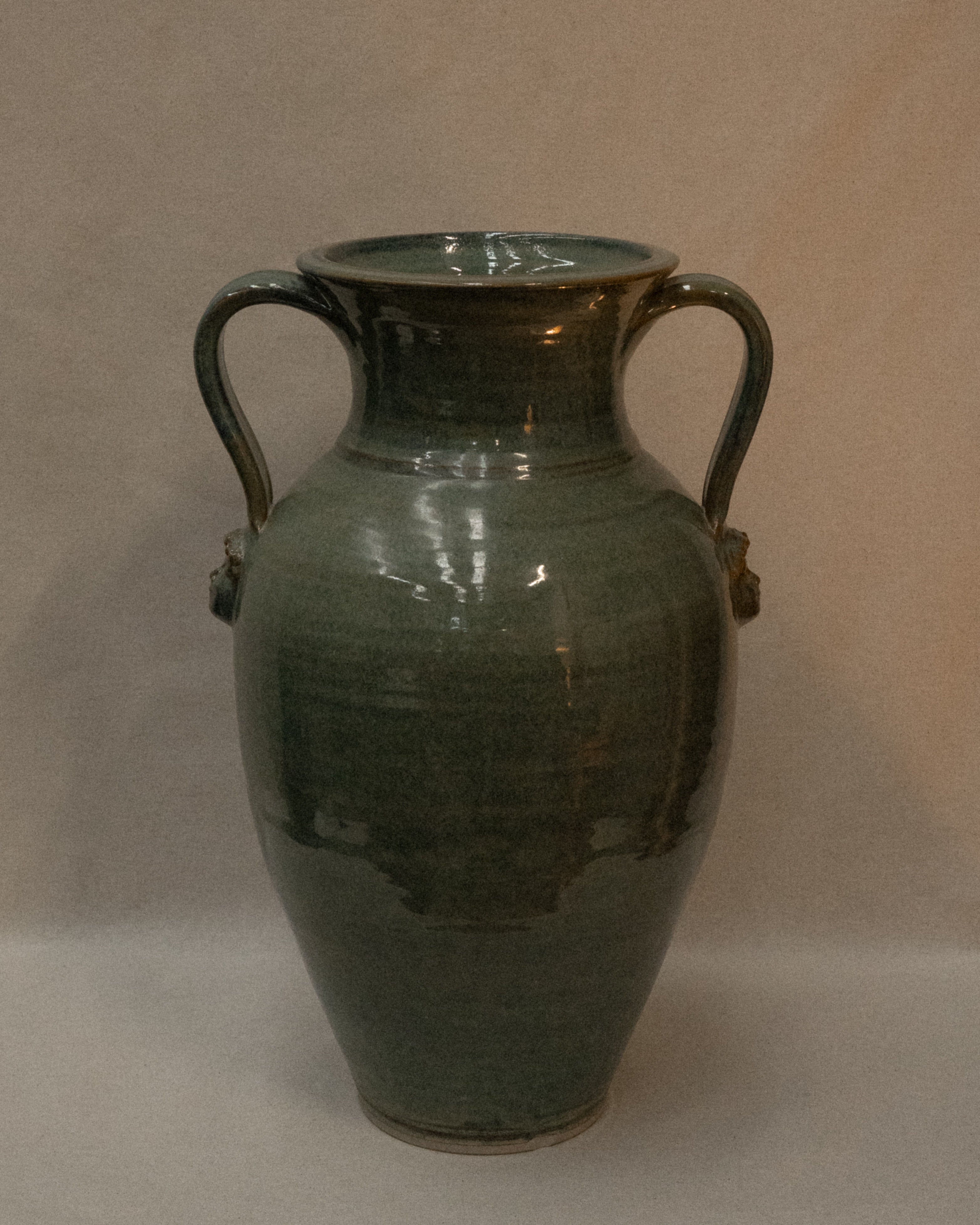 Large vase with handles and faces by Australian ceramicist Graeme Potter