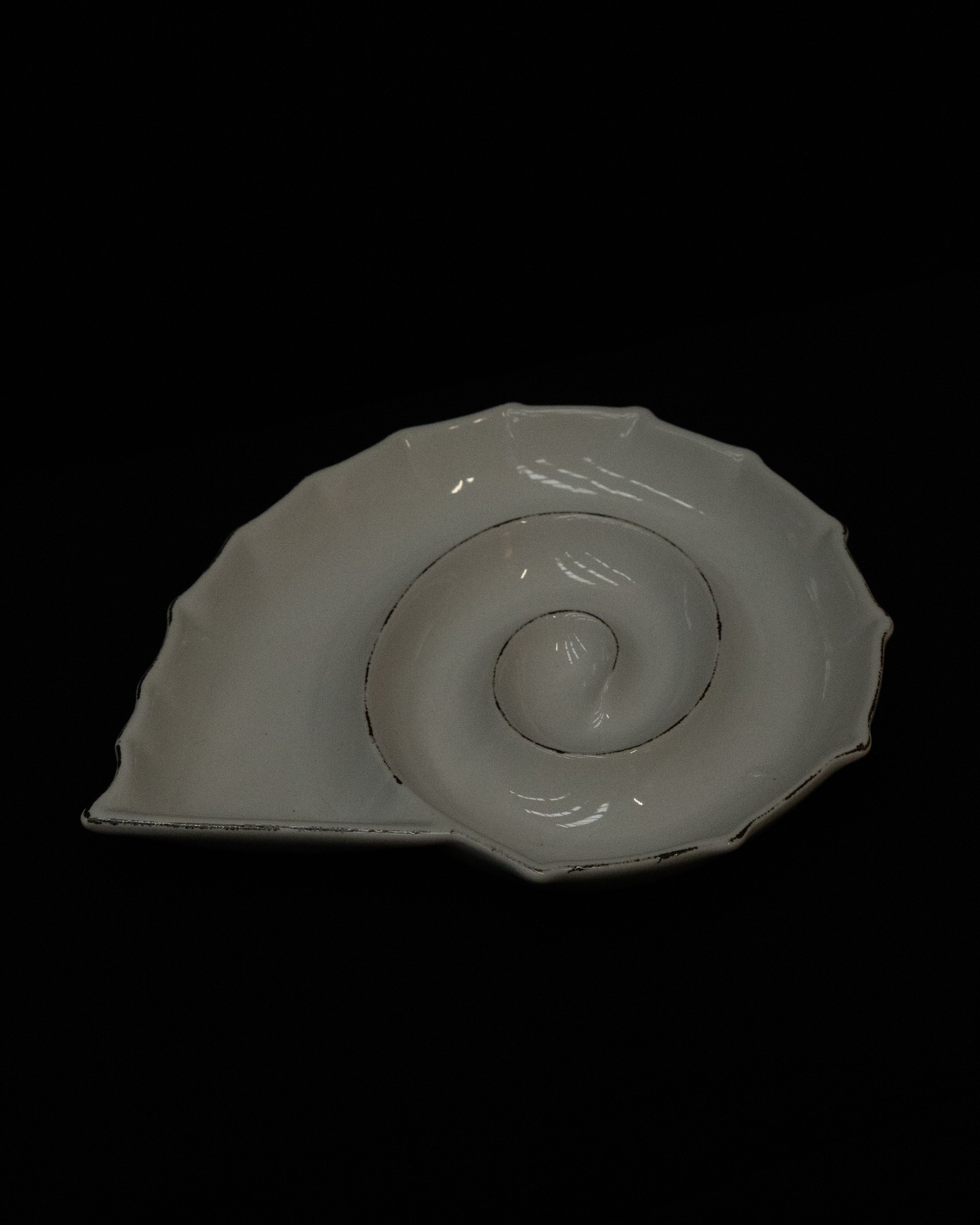 White ceramic spiral shell dish with 'exposed' edges