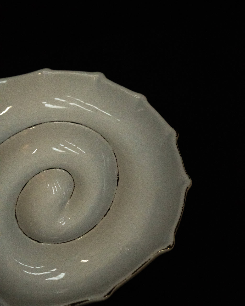 White ceramic spiral shell dish with 'exposed' edges