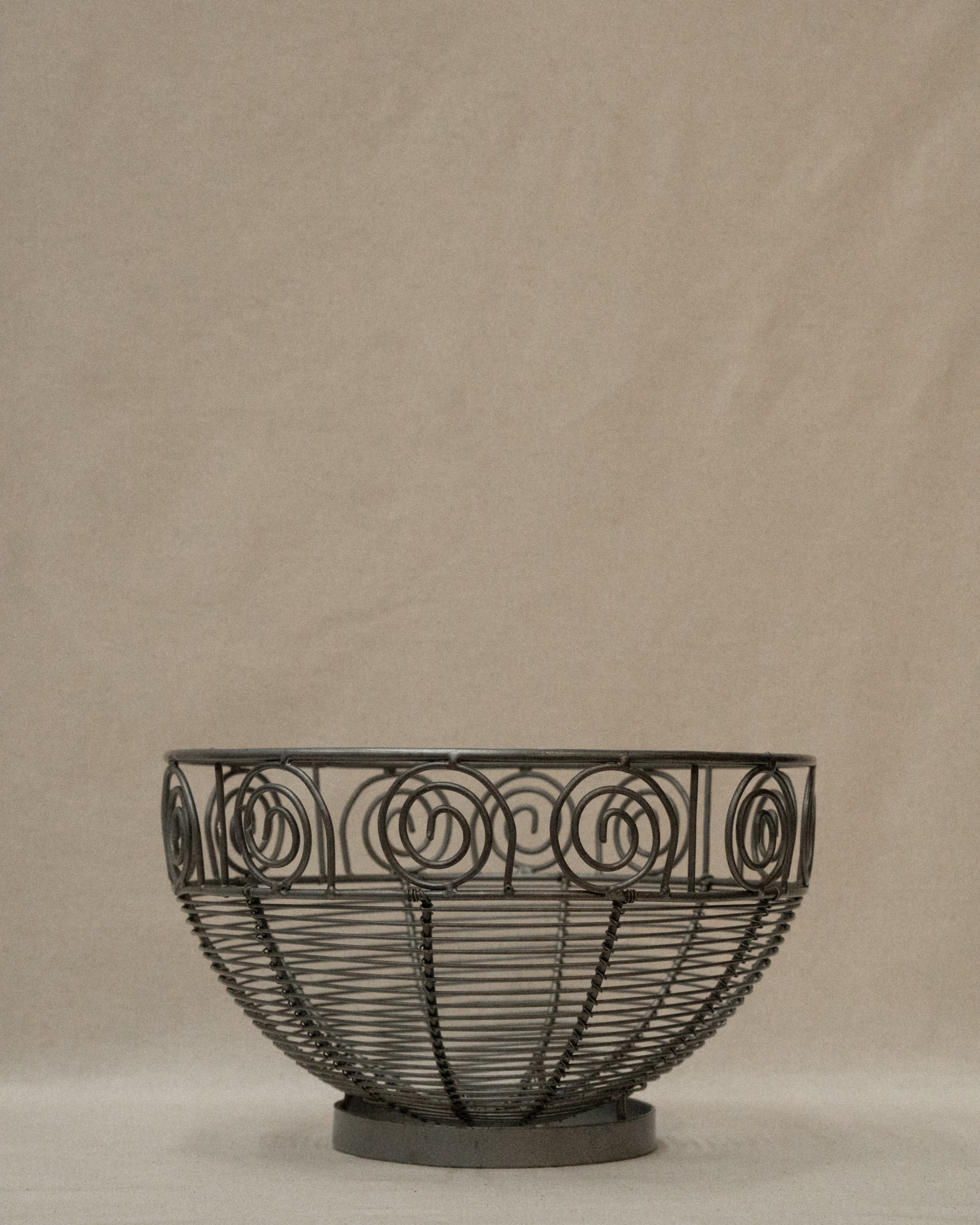 Wrought metal fruit bowl with spirals