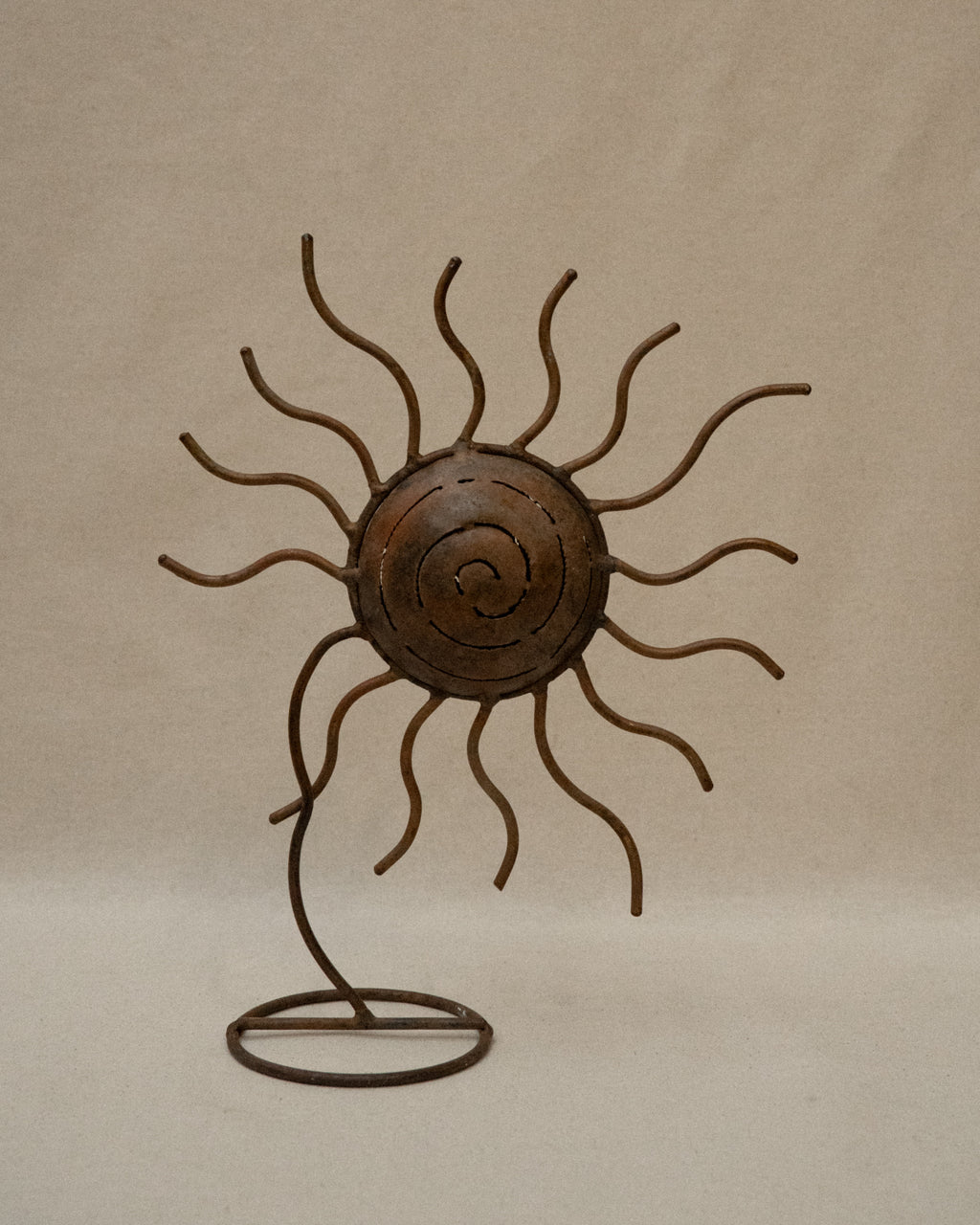 Metal spiral sun wavy rays sculpture with storage