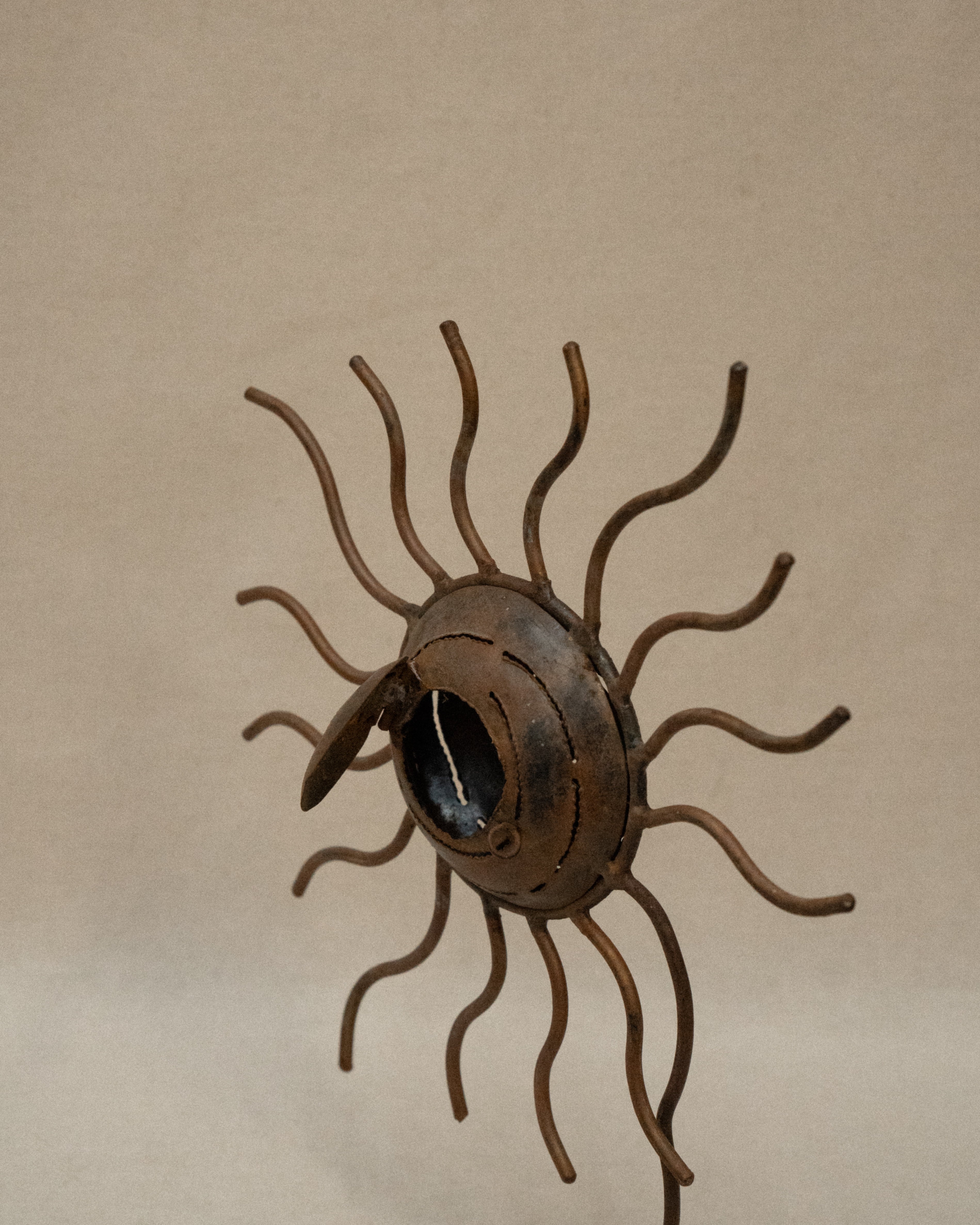 Metal spiral sun wavy rays sculpture with storage