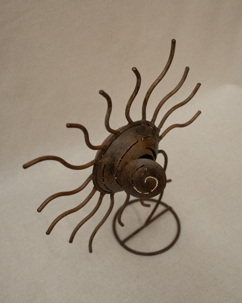 Metal spiral sun wavy rays sculpture with storage