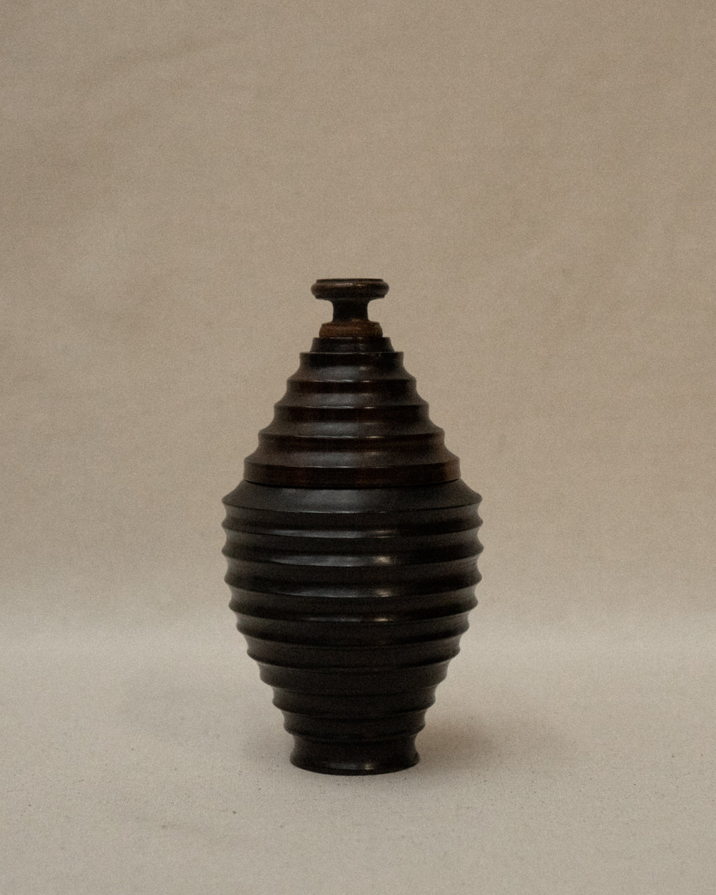 Dark wooden turned container with lid