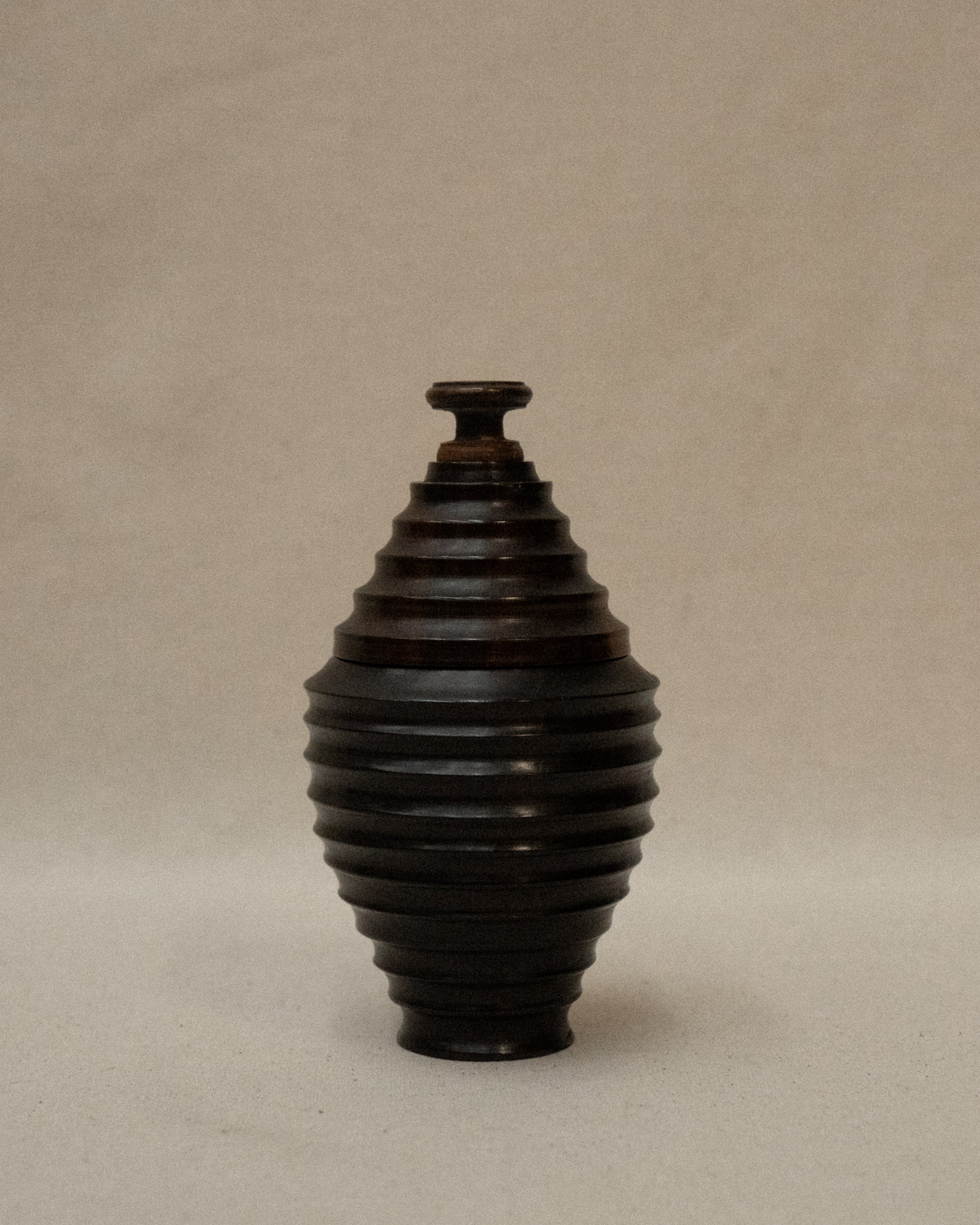 Dark wooden turned container with lid