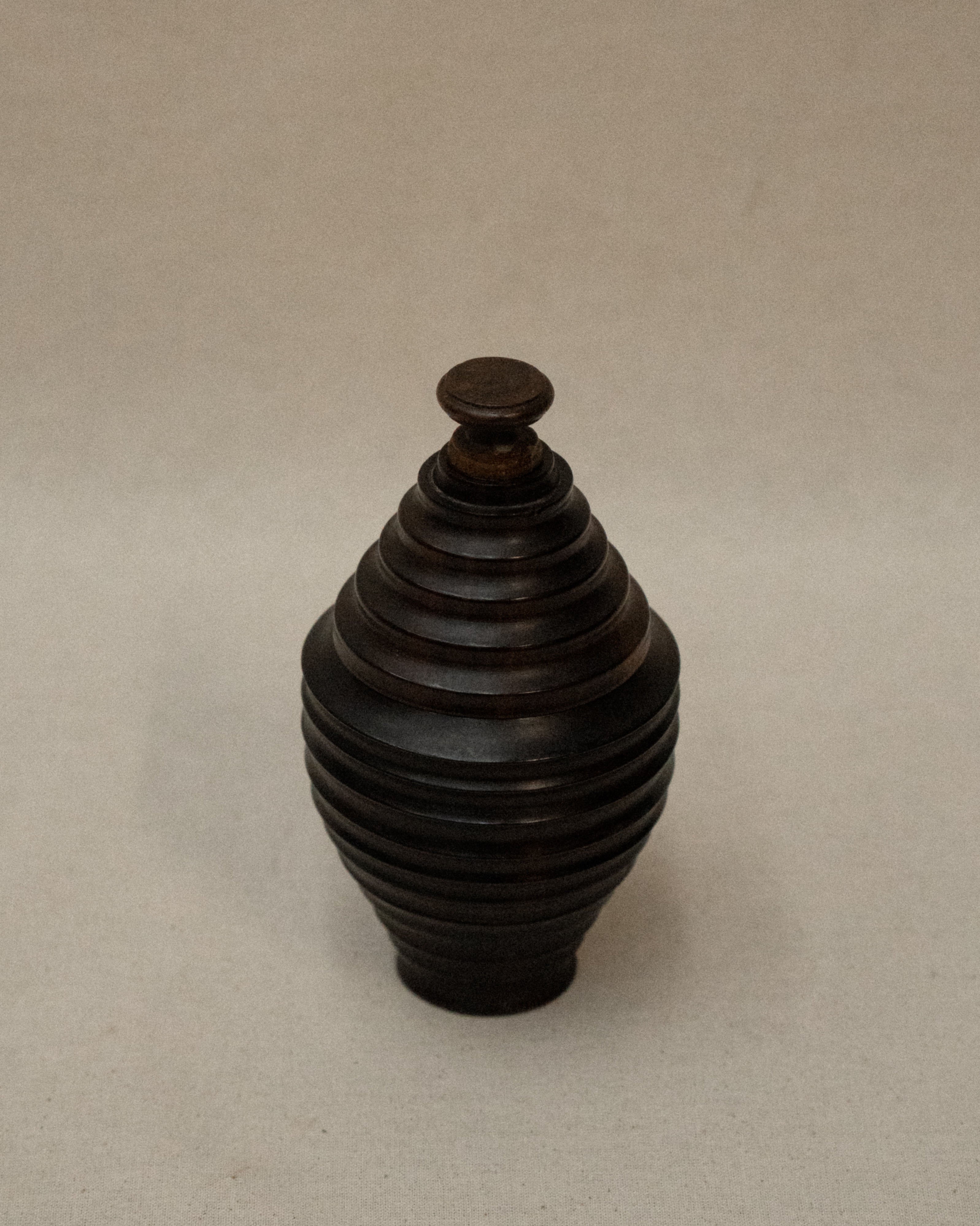 Dark wooden turned container with lid