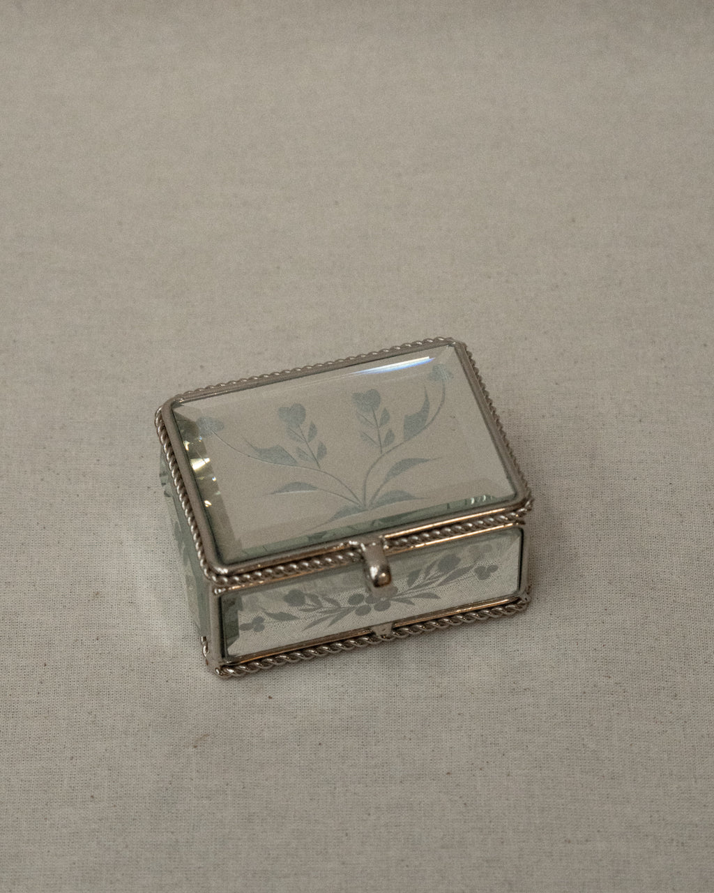 Mirrorred trinket box with etchings, rope edges, scroll handle and lined with fabric