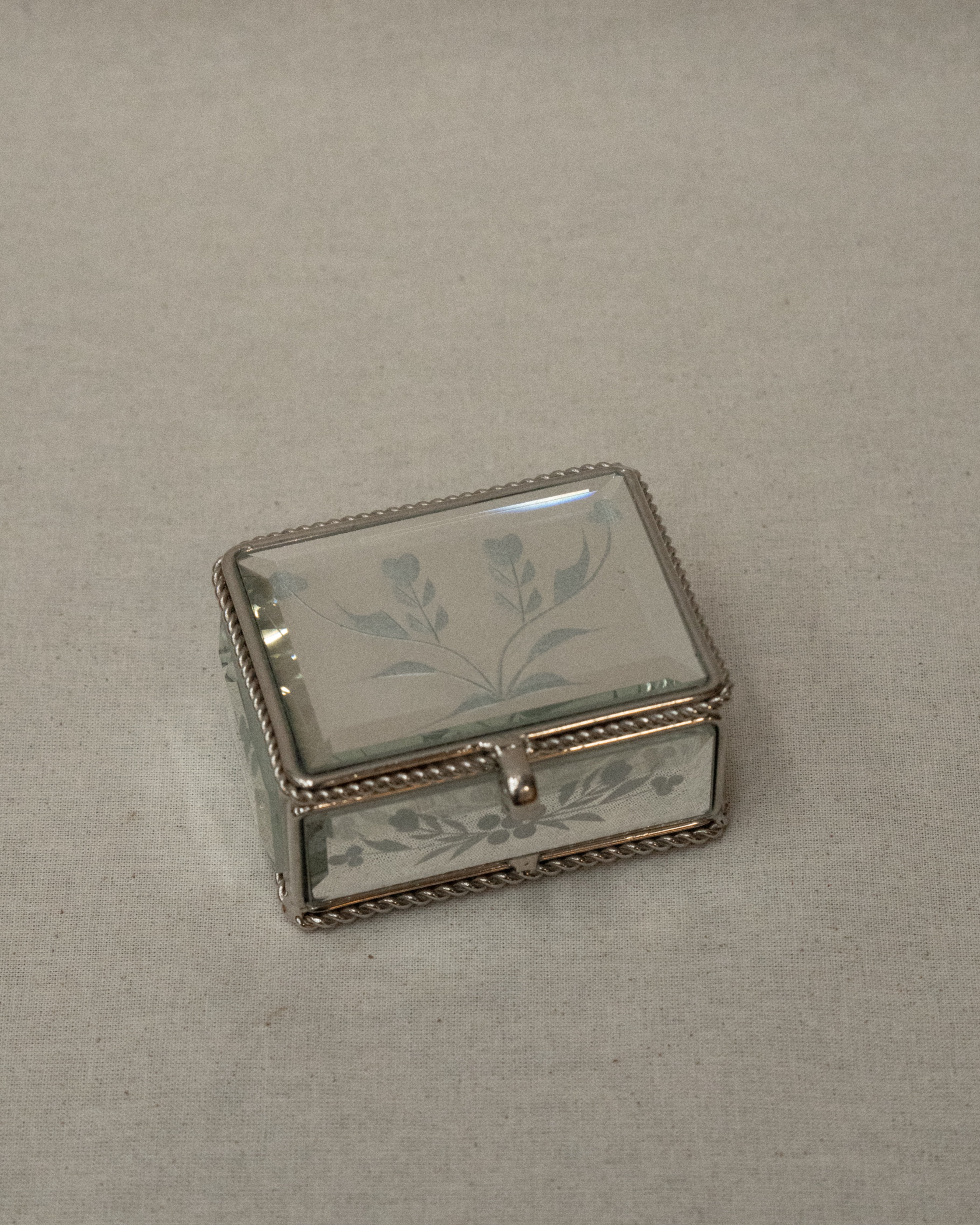 Mirrorred trinket box with etchings, rope edges, scroll handle and lined with fabric