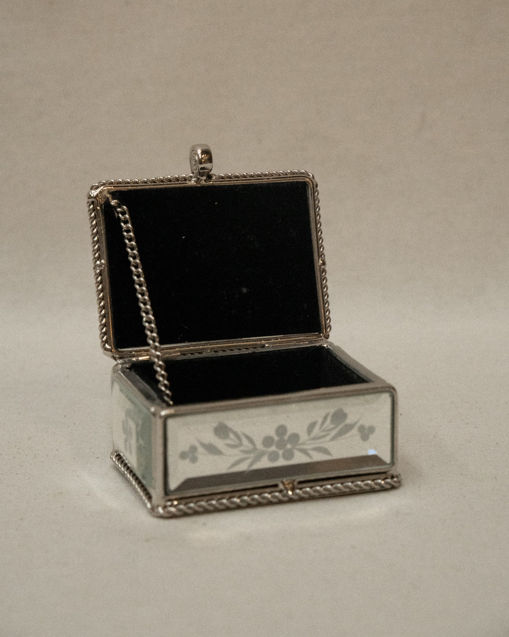 Mirrorred trinket box with etchings, rope edges, scroll handle and lined with fabric